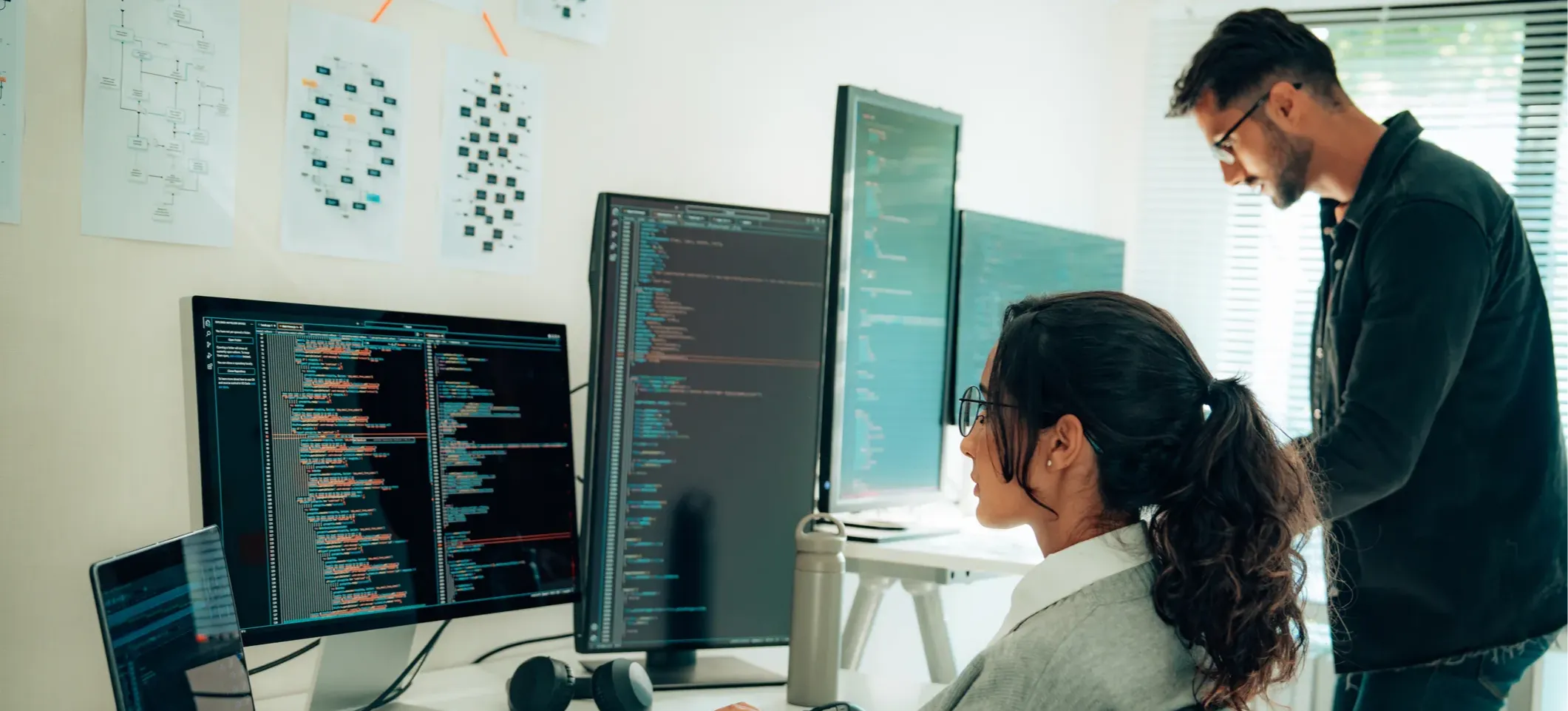 [Featured Image] Two cybersecurity analysts work to secure their organization’s network