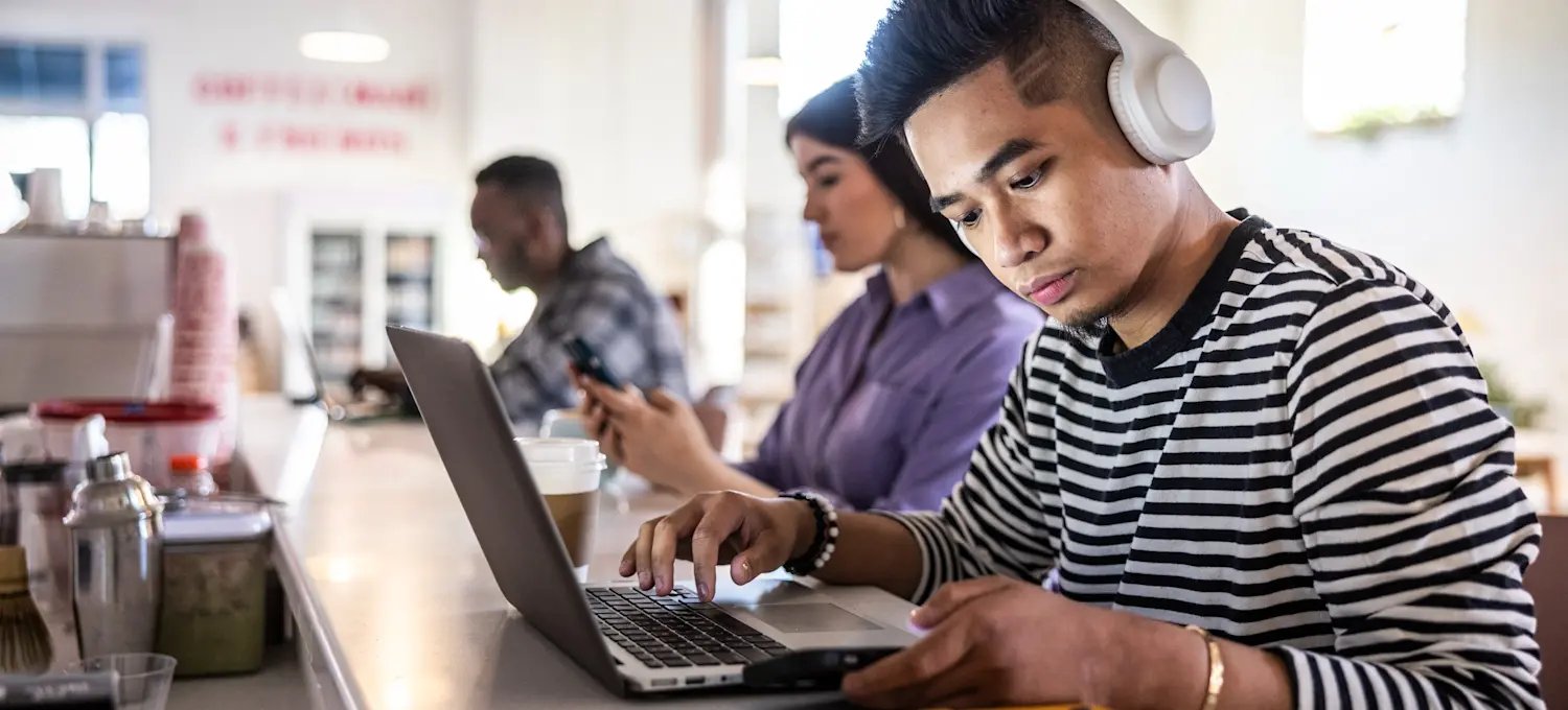 [Featured Image] A prospective college student looks at career path options on their laptop.

