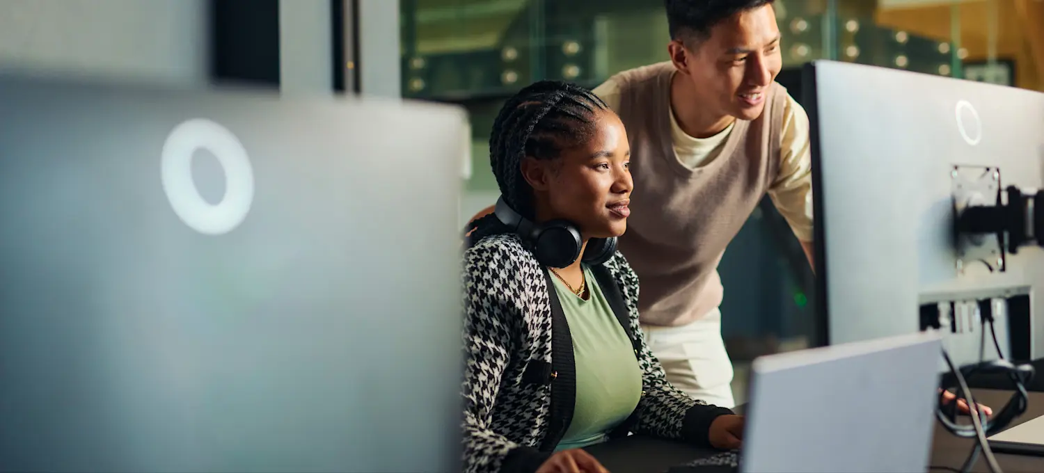[Featured Image]: Two data scientists collaborate to use machine learning to conduct social research. 
