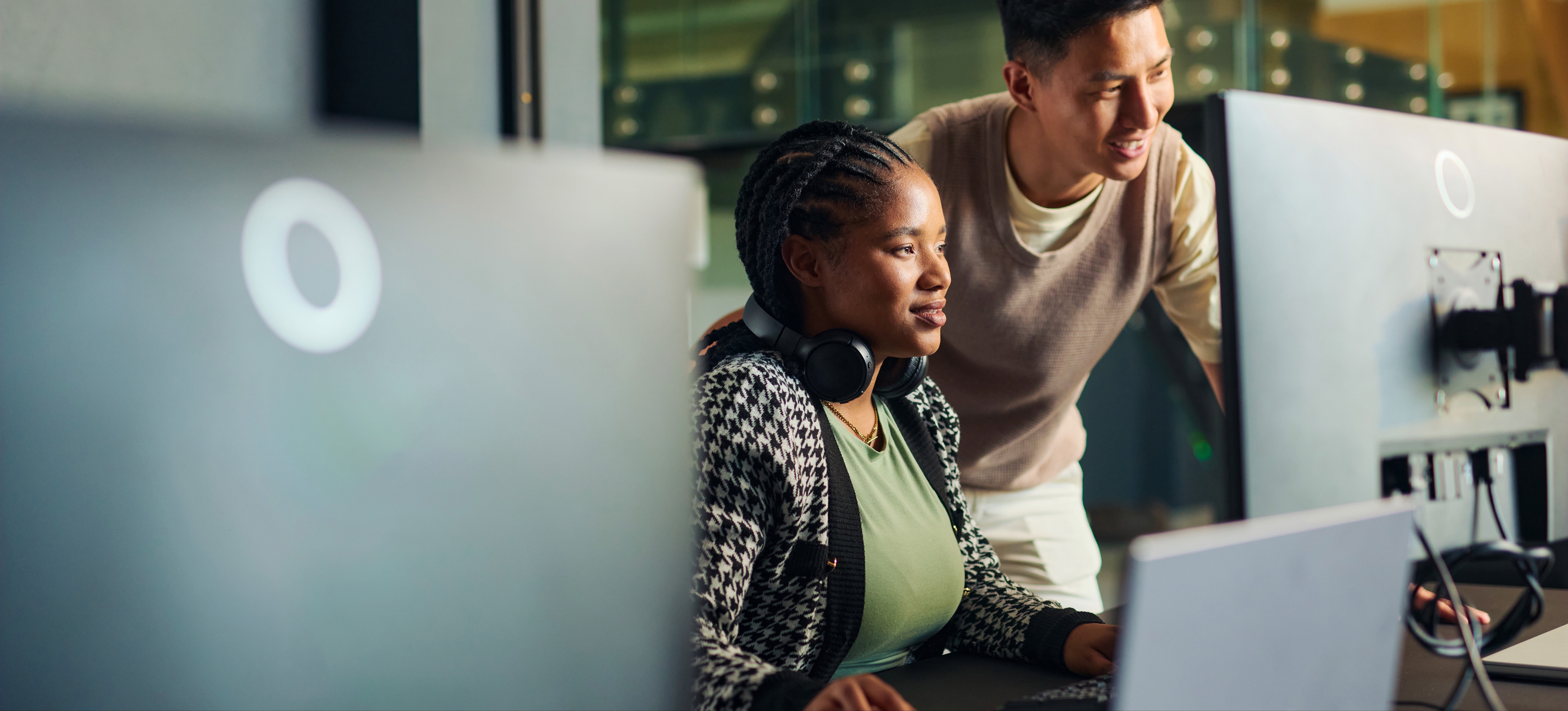 [Featured Image]: Two data scientists collaborate to use machine learning to conduct social research. 
