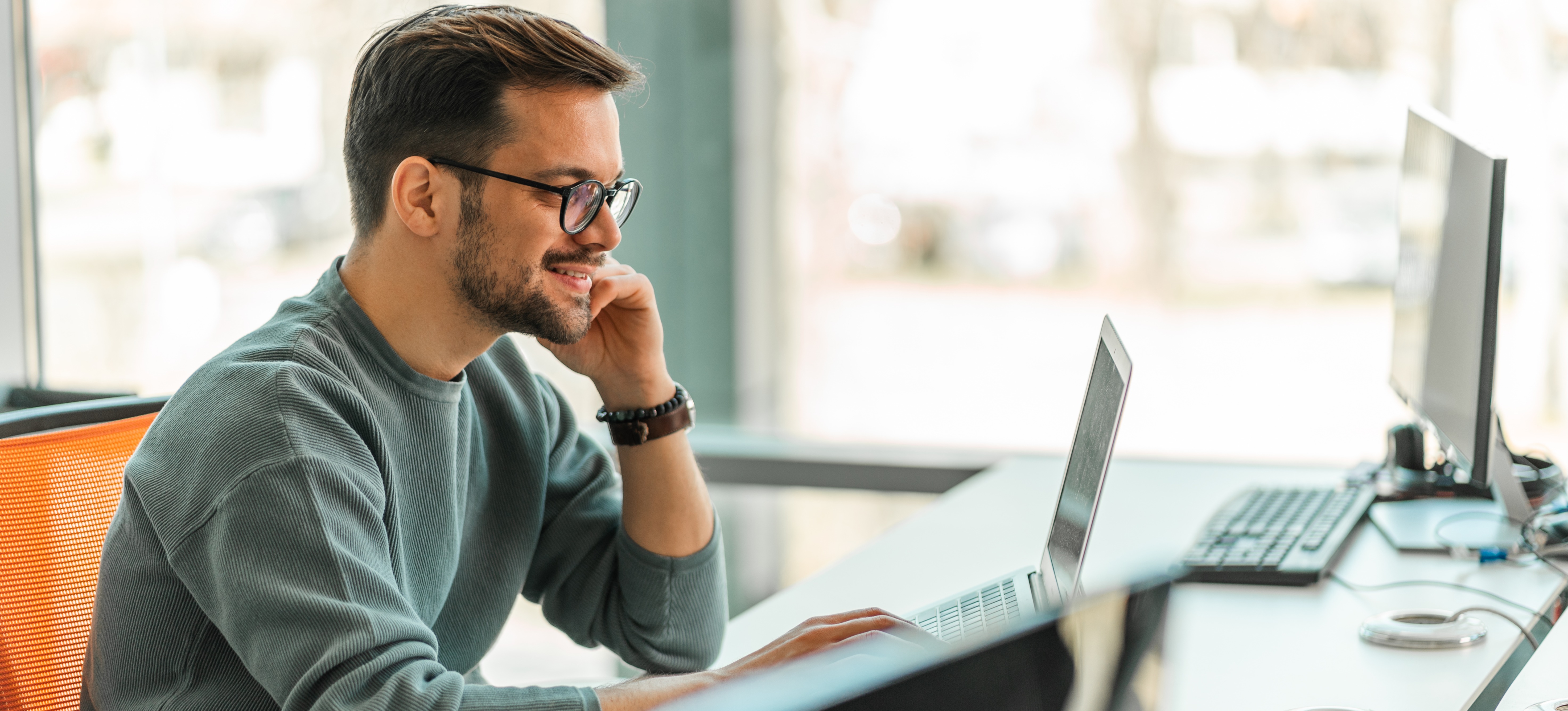 [Featured Image]: A man diligently works on designing an efficient database schema to optimize data organization and retrieval.
