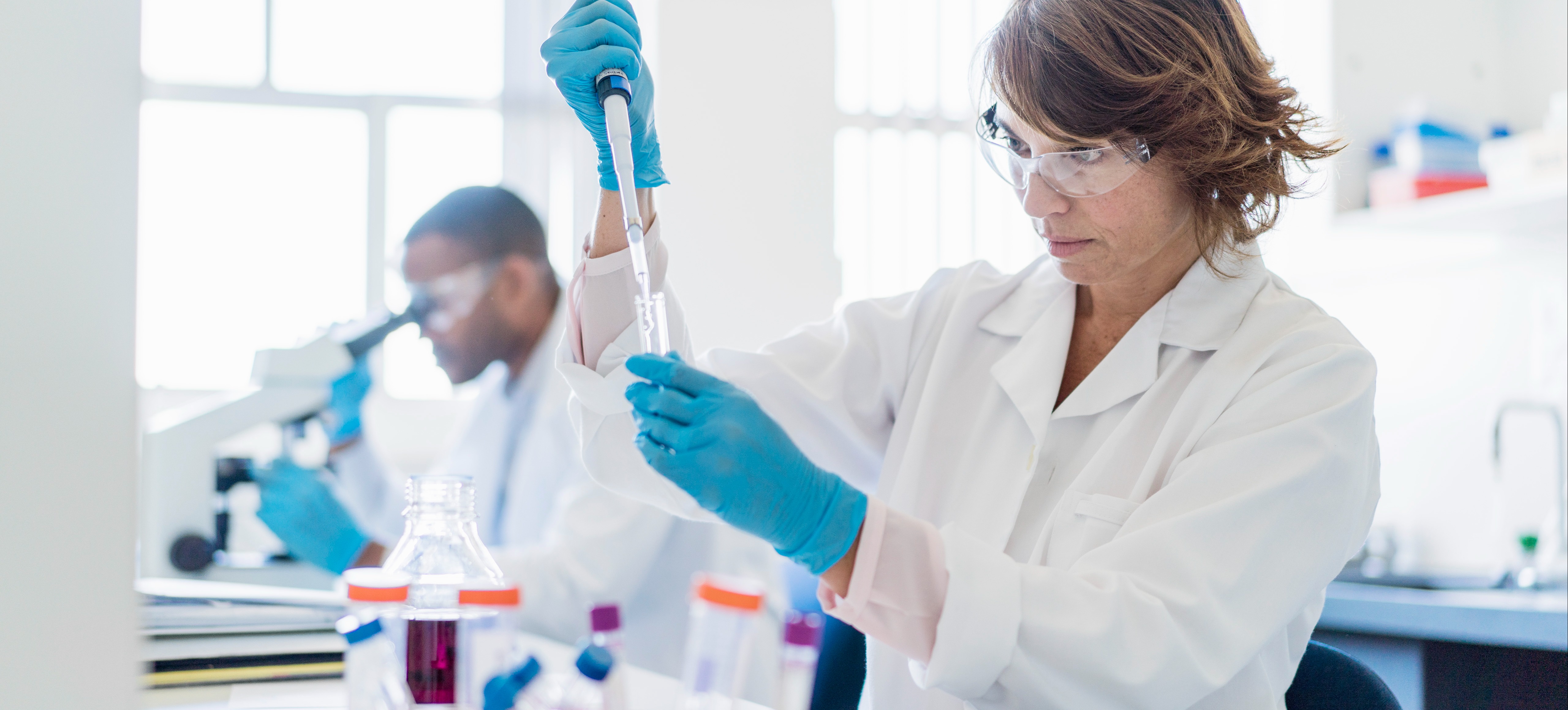 [Featured Image] A person studying for their doctorate is experimenting with chemicals in a lab.