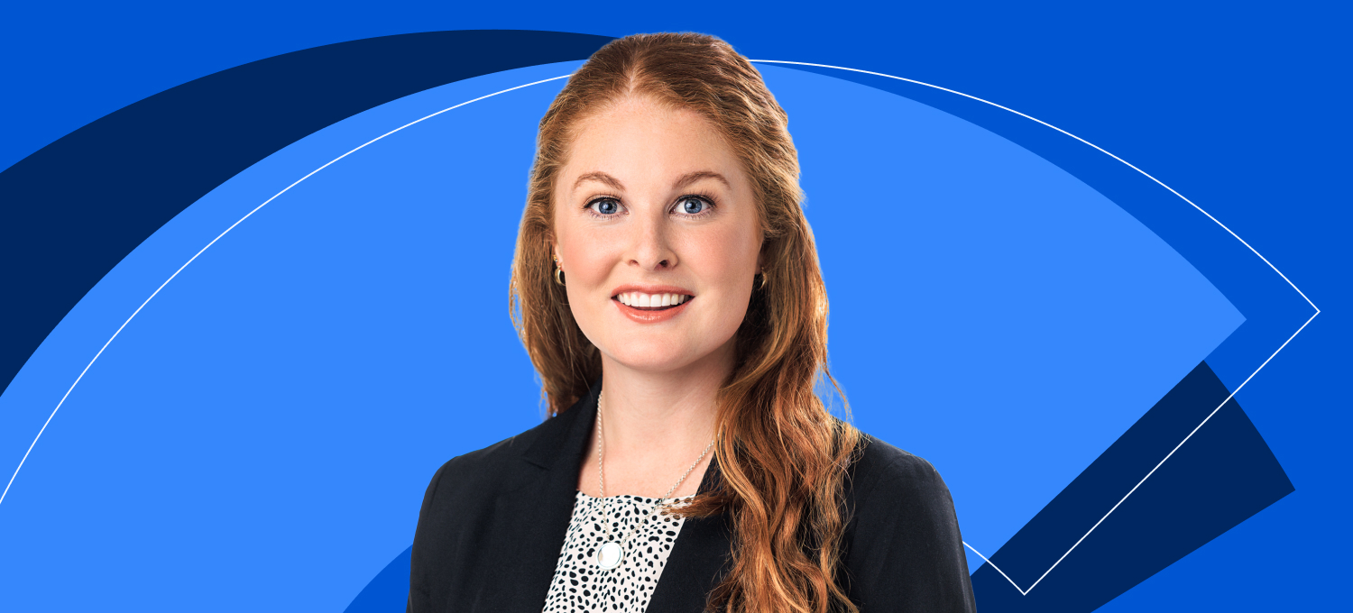 [Featured image] Illinois Tech MBA student Janie Butler poses in front of a blue Coursera background.