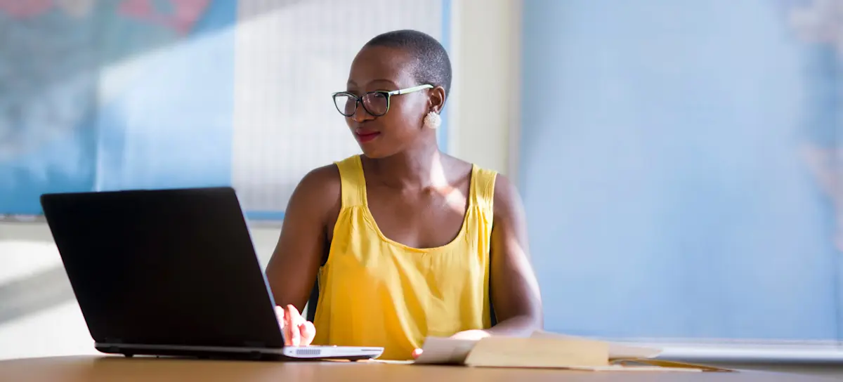 [Featured Image] A person taking CLEP exams studies with a laptop and notes.