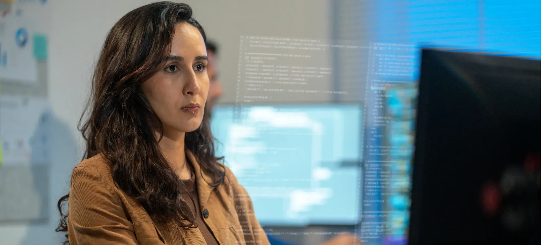 [Featured Image] A developer works at a computer, using various resources to build AI agents.