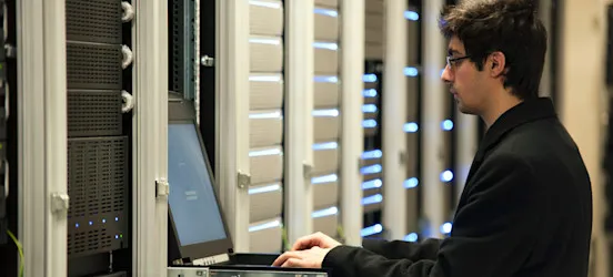 [Featured image]: A system administrator working on a computer.
