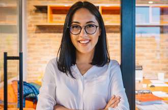 [Featured image] Woman standing in front of an office