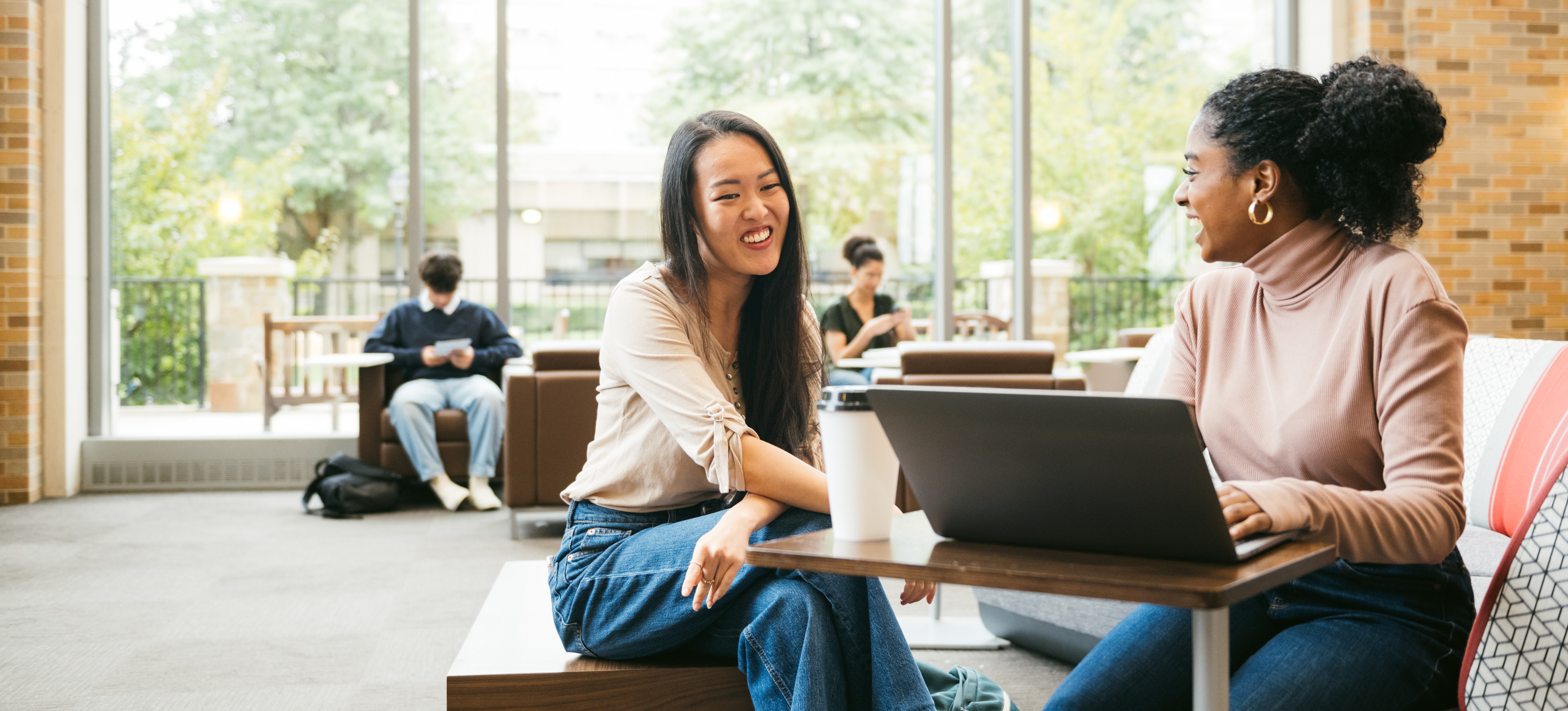 [Feature Image] Two university learners get together after looking up “What is a graduate degree” to plan their educational paths moving forward.
