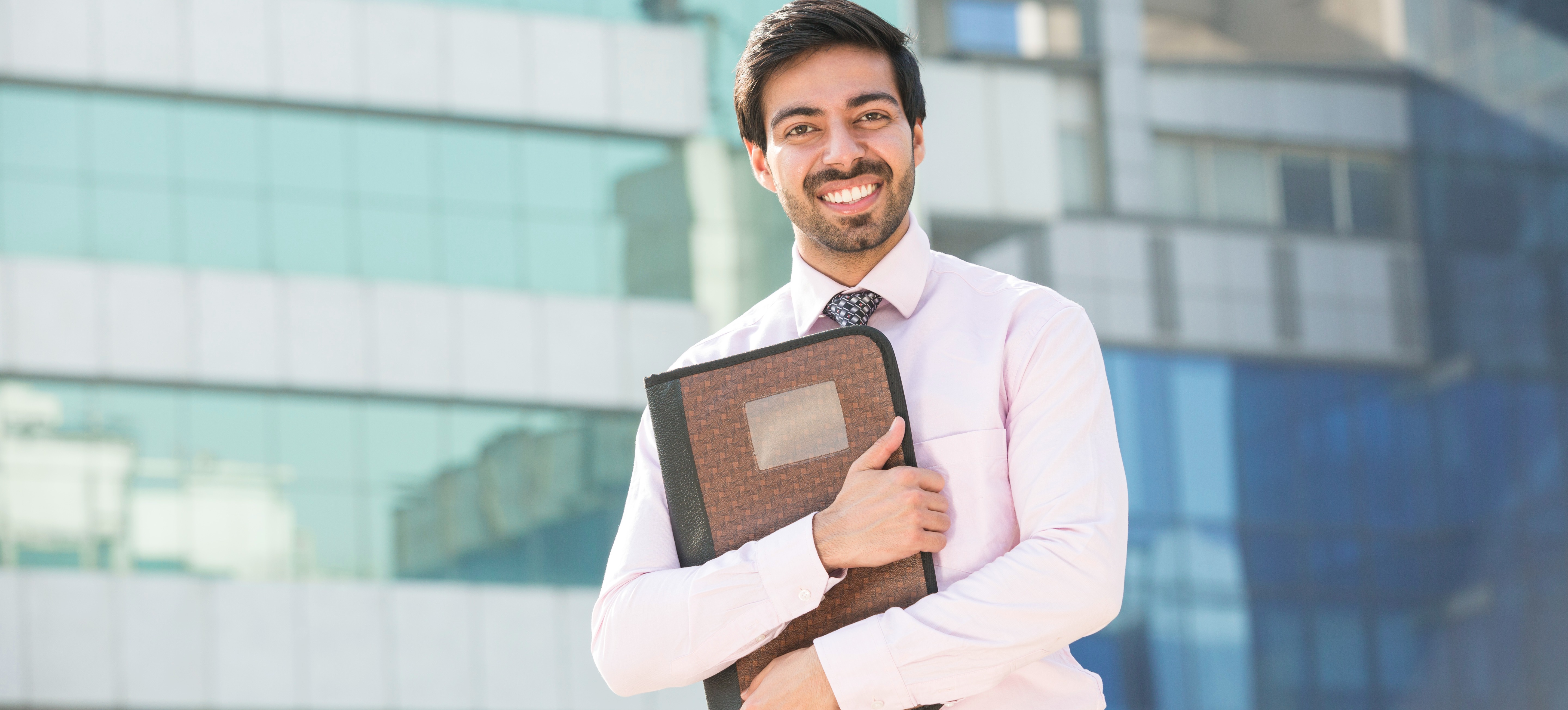 An employee standing outside his office.