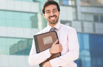 An employee standing outside his office.