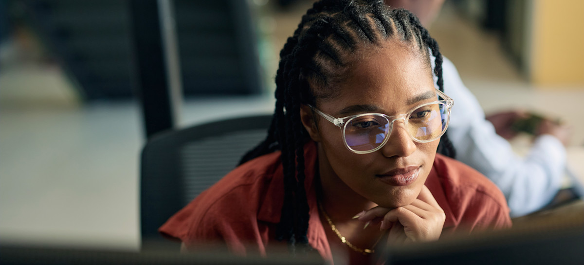 [Featured Image] A data analyst studies clustering algorithms comparison on their computer.