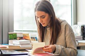 [Featured Image] A student studies for an exam.