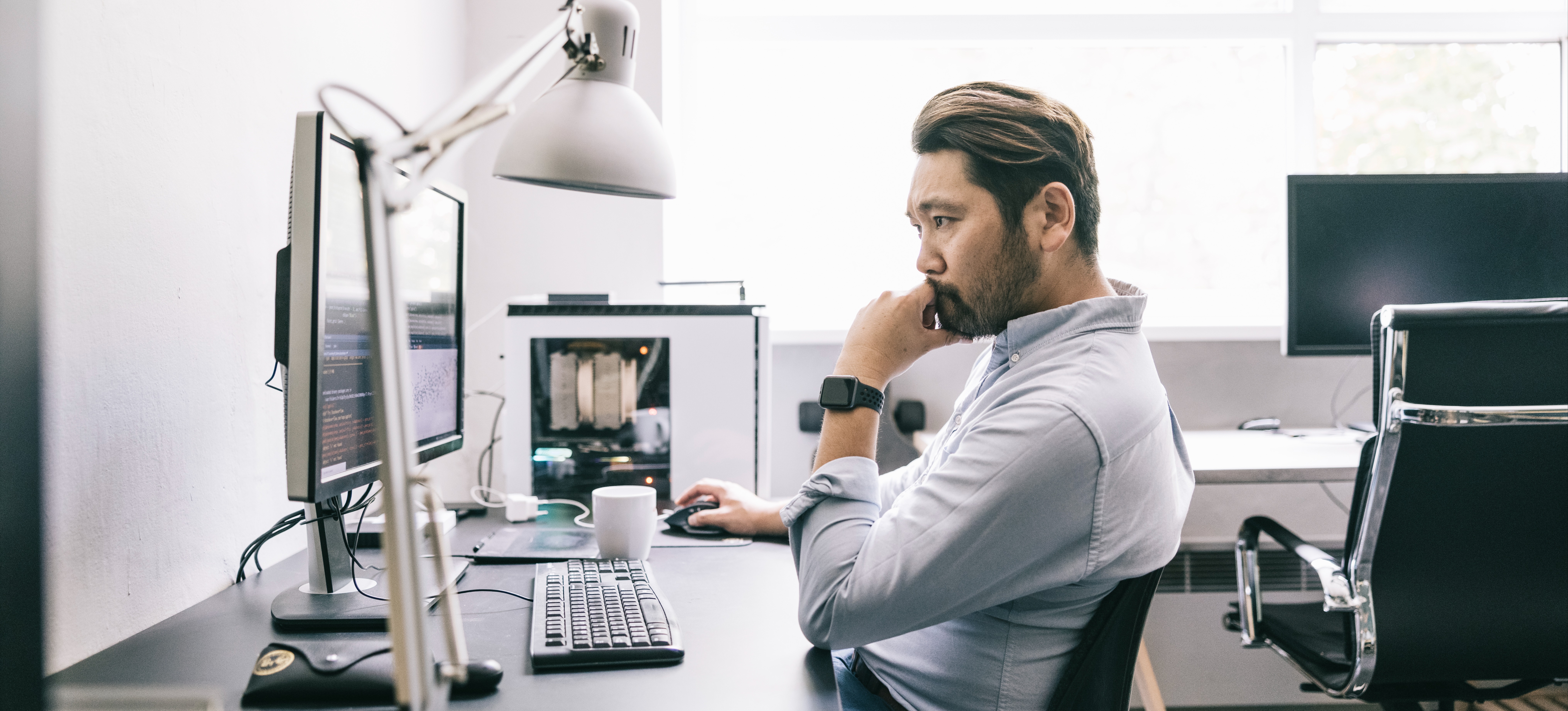 [Featured image] An AI engineer works at a computer using prompt engineering to create a chatbot.