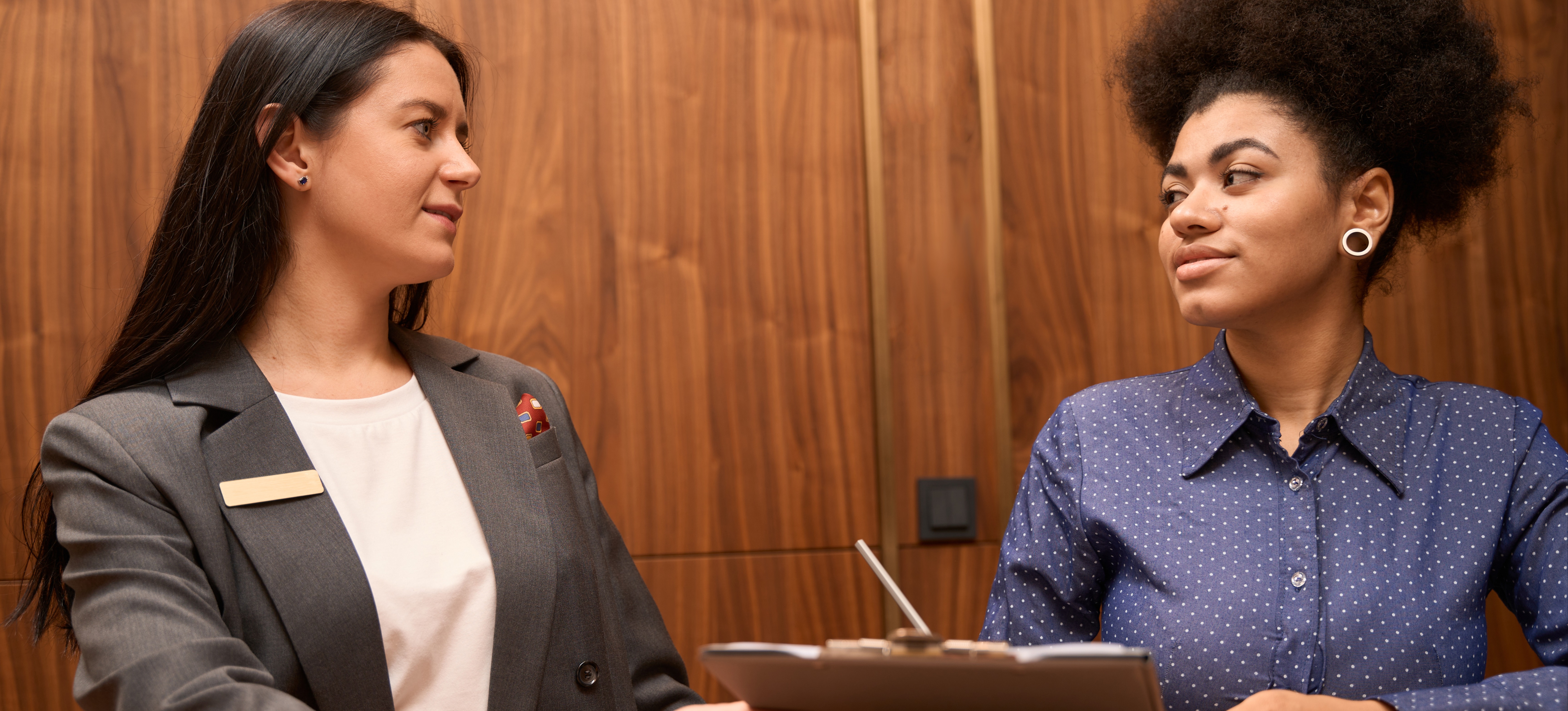 [Featured Image]: Two colleagues with a public health degree discuss what an MPH is.
