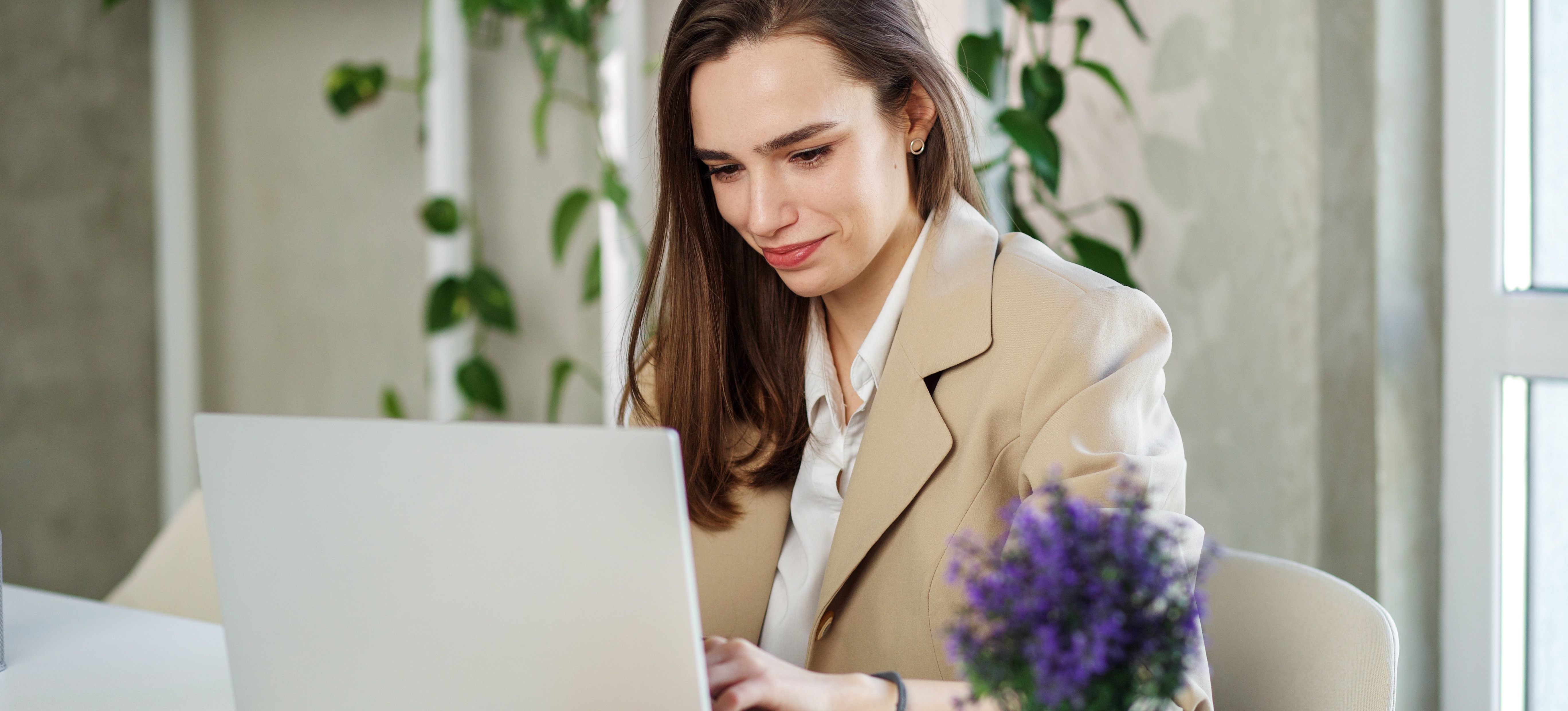 [Featured Image] A young professional who wants to change careers uses a laptop to research whether you need a degree for cybersecurity.   
