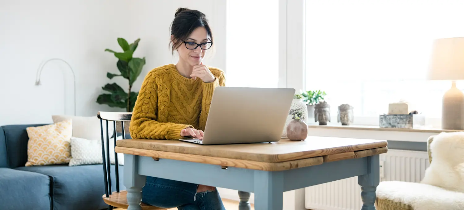 [Featured Image] A person works on a laptop computer at home, learning about Google Sheets versus Excel.
