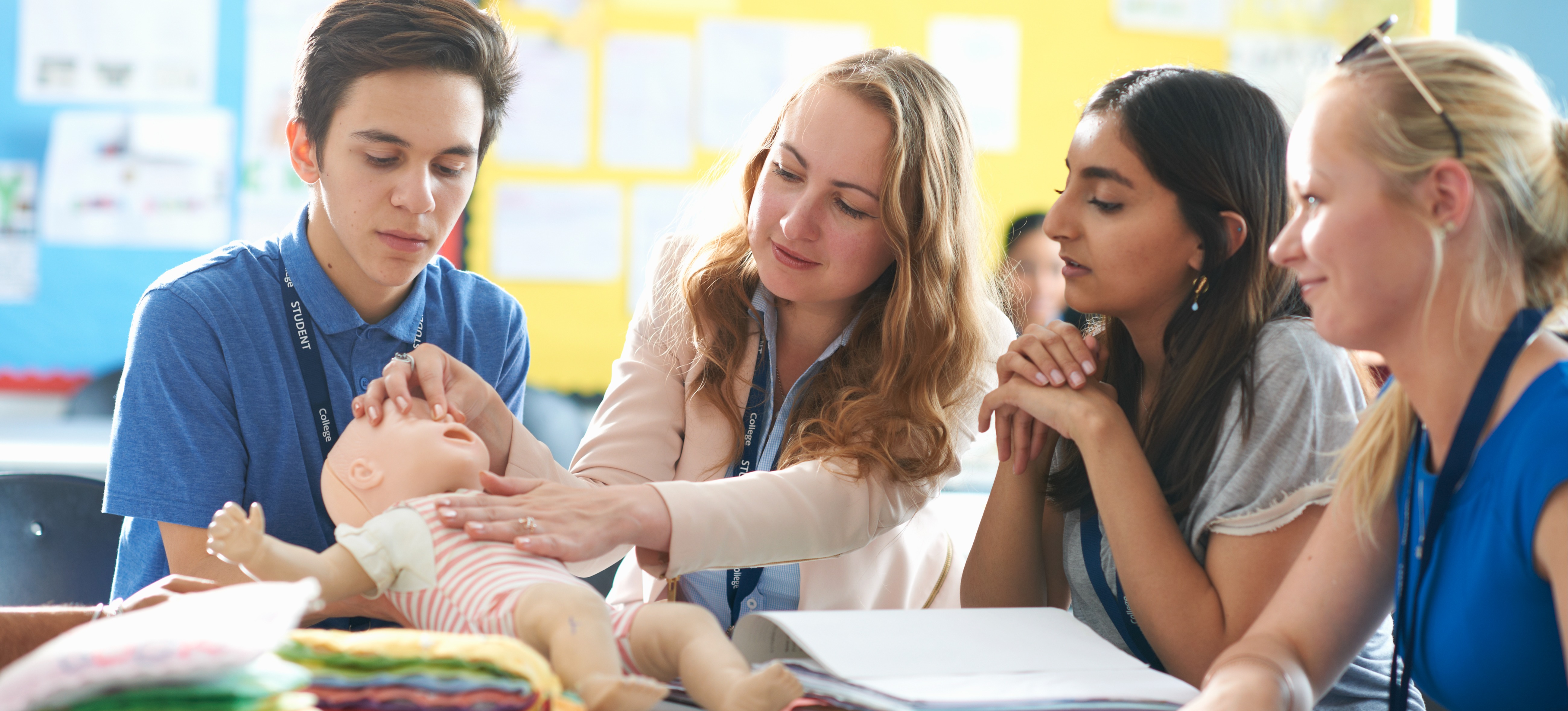 [Featured Image] Students are learning cpr for children to help them get an NVQ in childcare.