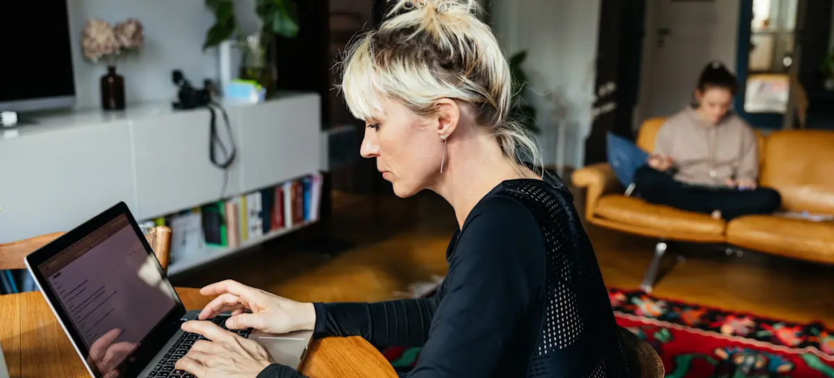 [Featured Image] A person working on their laptop at home is sending a test email in Mailchimp for a marketing project.