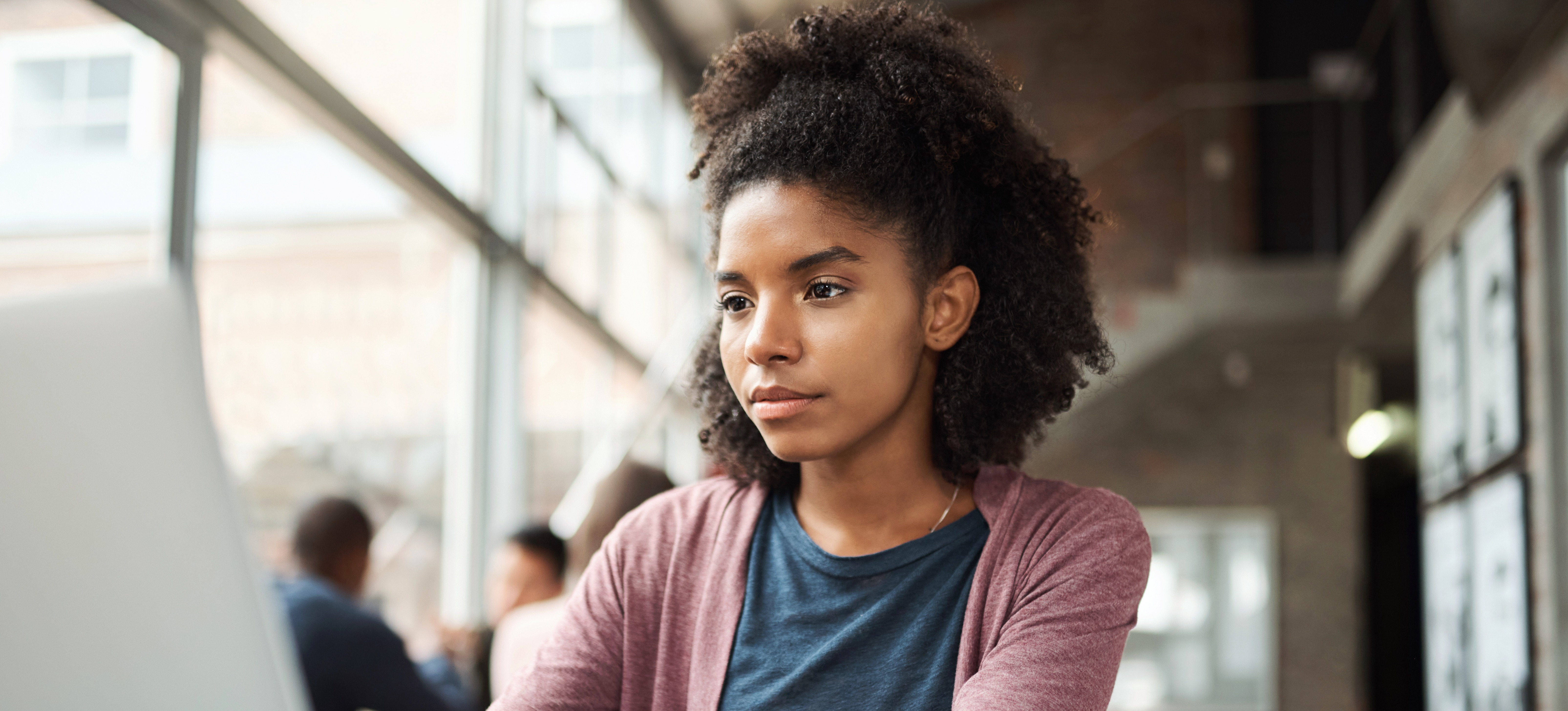 [Feature Image] An aspiring data scientist researches the best way to learn R on their laptop in a well-lit environment.