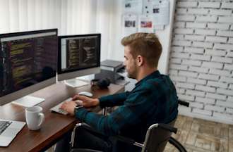 [Featured Image] A blockchain developer works on code in front of several monitors.