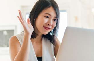 [Featured image] A young woman sits at a laptop and participates in a video chat with a mentor explaining how to become a data analyst without a degree.
