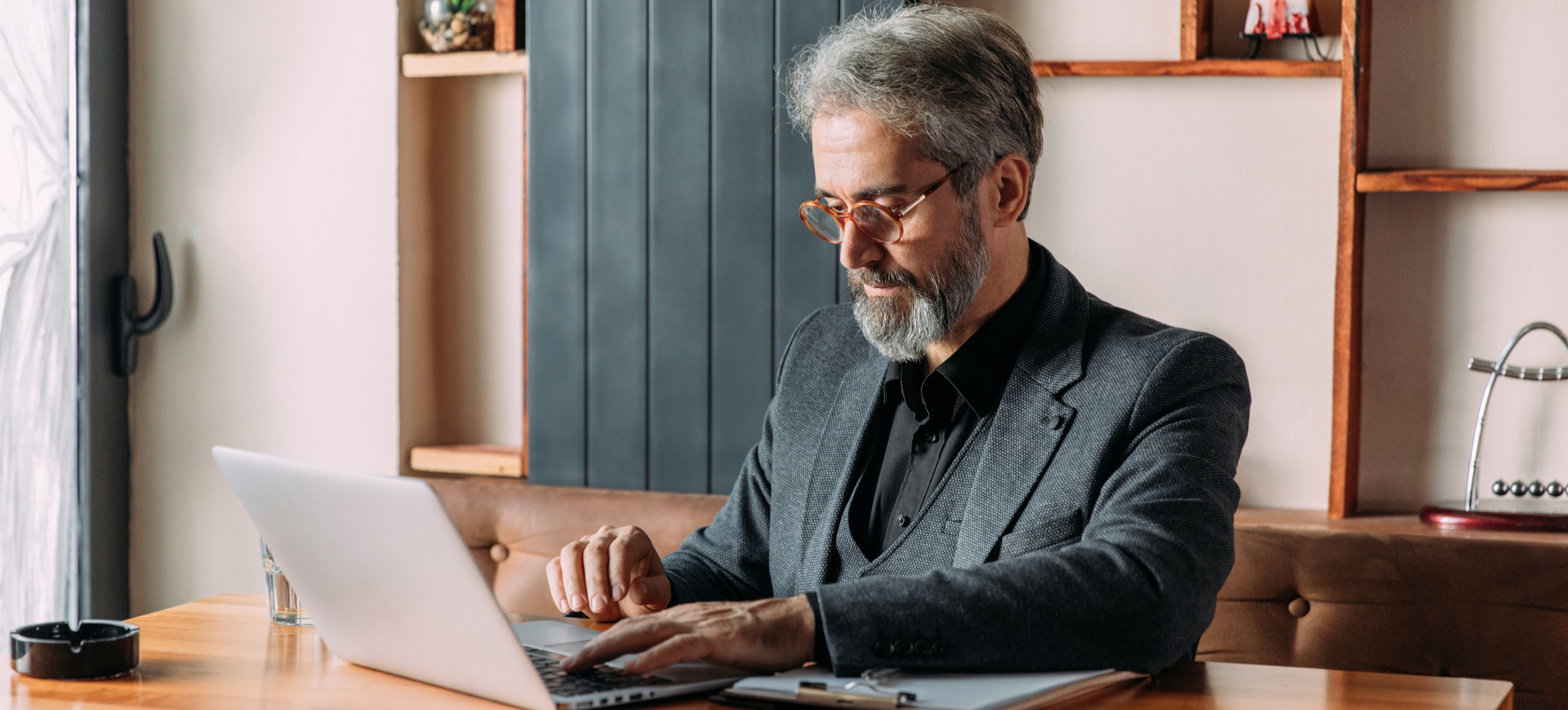 [Featured Image] A man works on a laptop. 