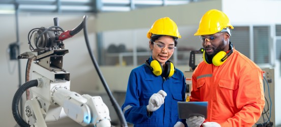 [Featured image] Two industrial hygienists are discussing and checking the conditions of the workplace to see if there are hazards that have to be corrected. 