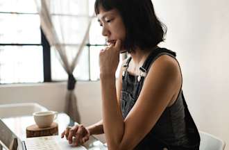 [Featured image] UX designer works at a laptop computer.