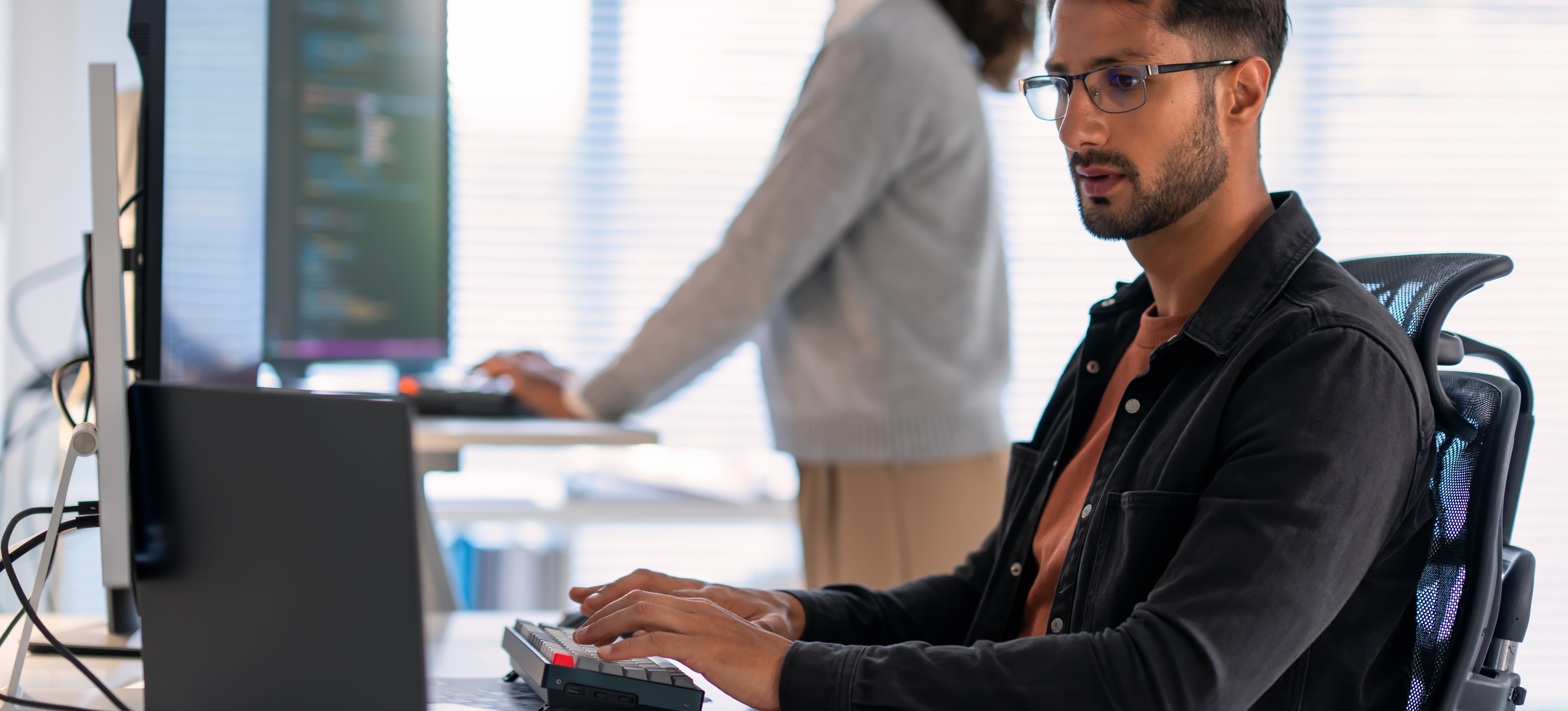 [Featured Image] A computer programmer is using the penetration testing technique to imitate a cybersecurity attack.