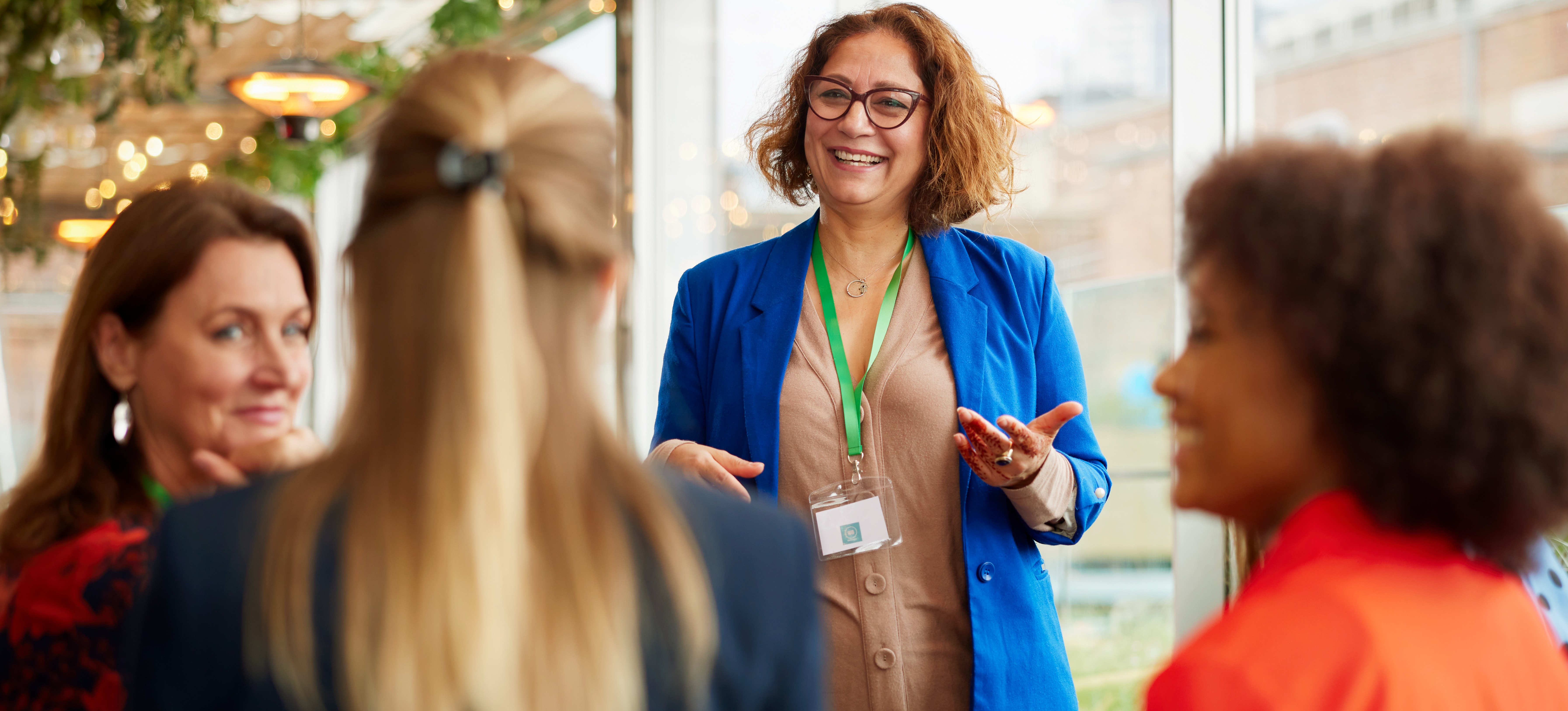 [Featured Image] A businesswoman leading a professional meeting, presenting key insights on woman-owned business certification in a corporate setting.