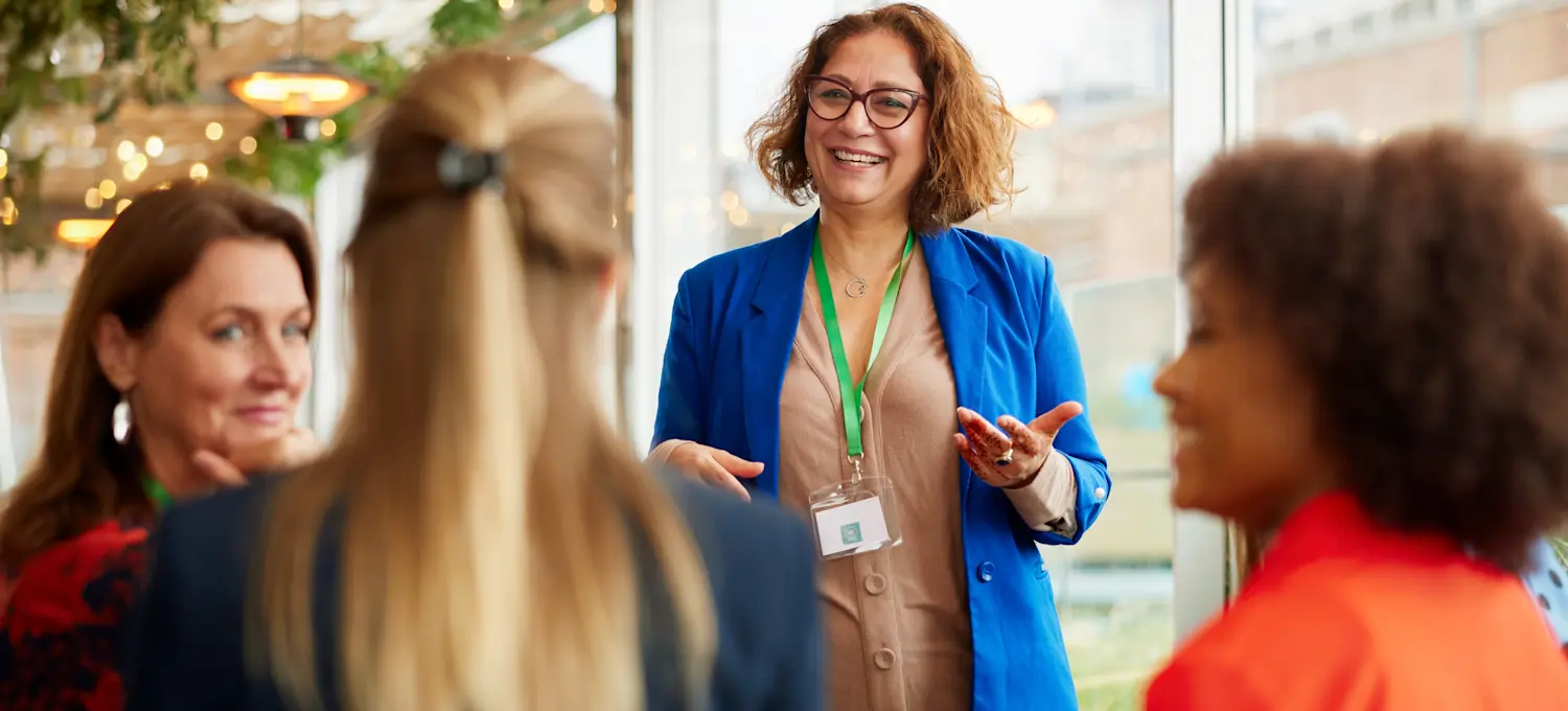 [Featured Image] A businessperson leading a professional meeting, presenting key insights on a business certification in a corporate setting.