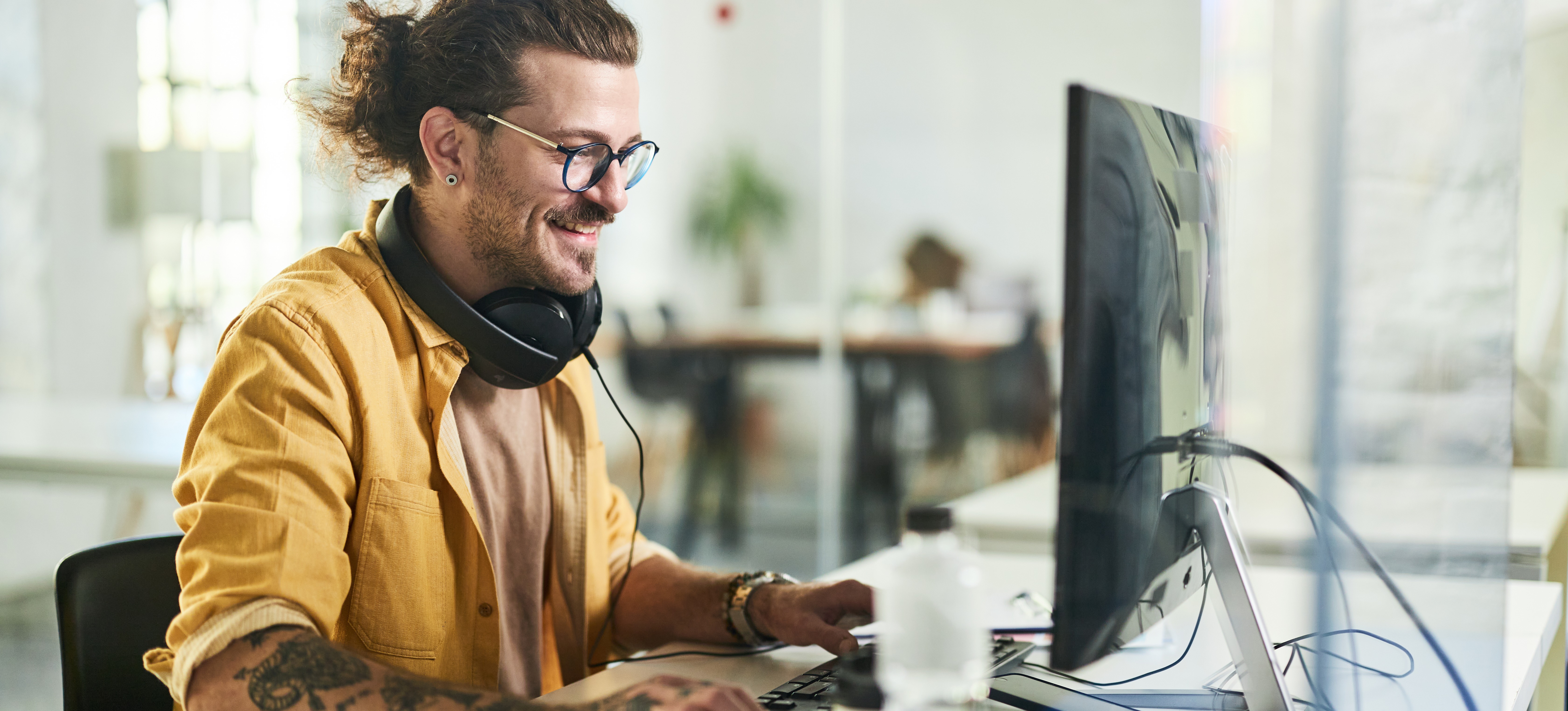 [Feature Image] An aspiring game developer researches the best way to learn C# for Unity on their desktop computer.
