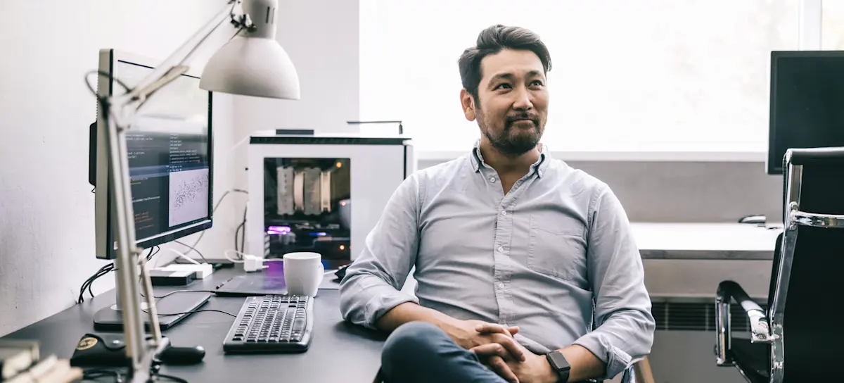[Featured image] A machine learning engineer sits in his home office thinking about how to use decision trees in machine learning.
