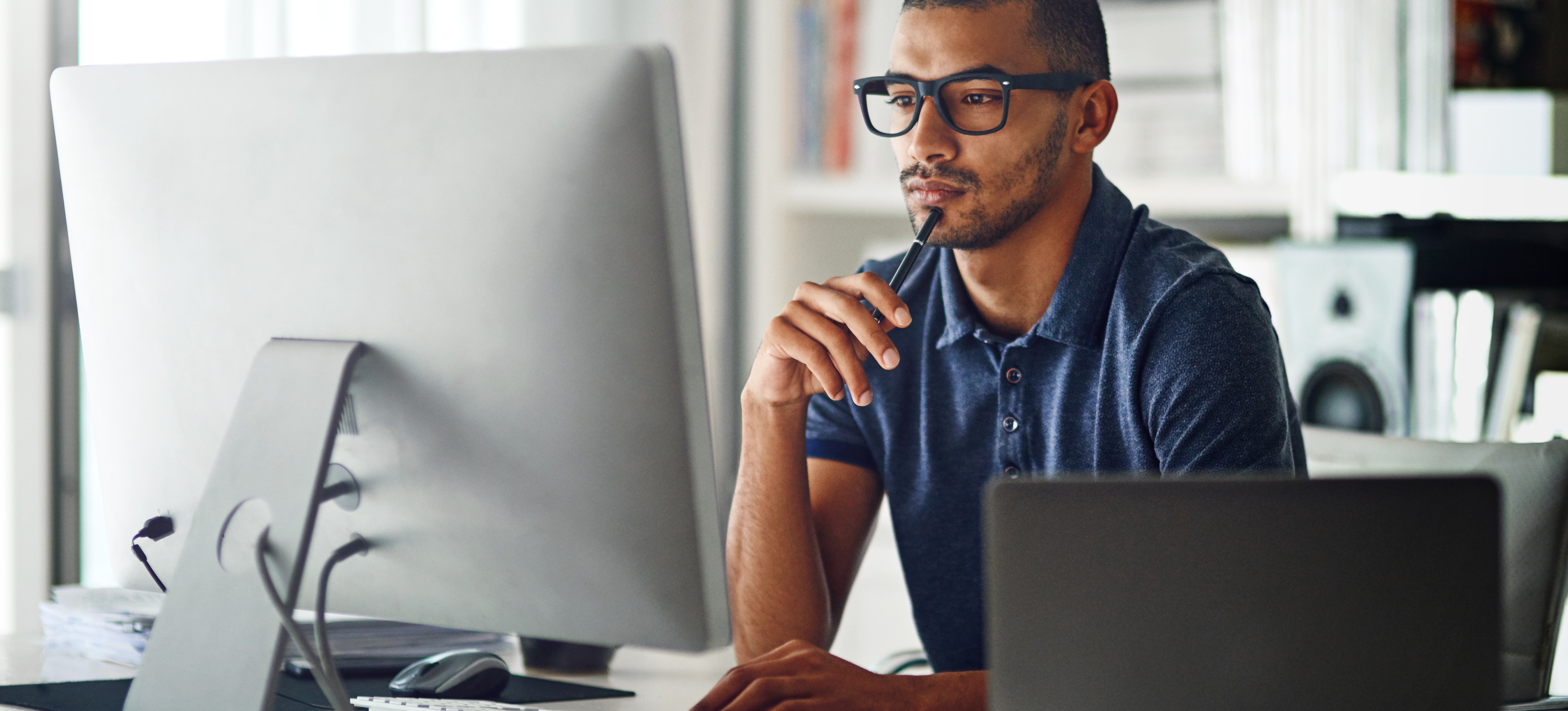 [Featured image] A machine learning engineer sits at his office computer and researches bias versus variance in machine learning.