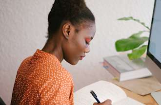 [Featured Image] A person in an orange shirt studies for a DevOps certification.