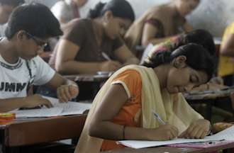 Students are seen writing their entrance examinations.