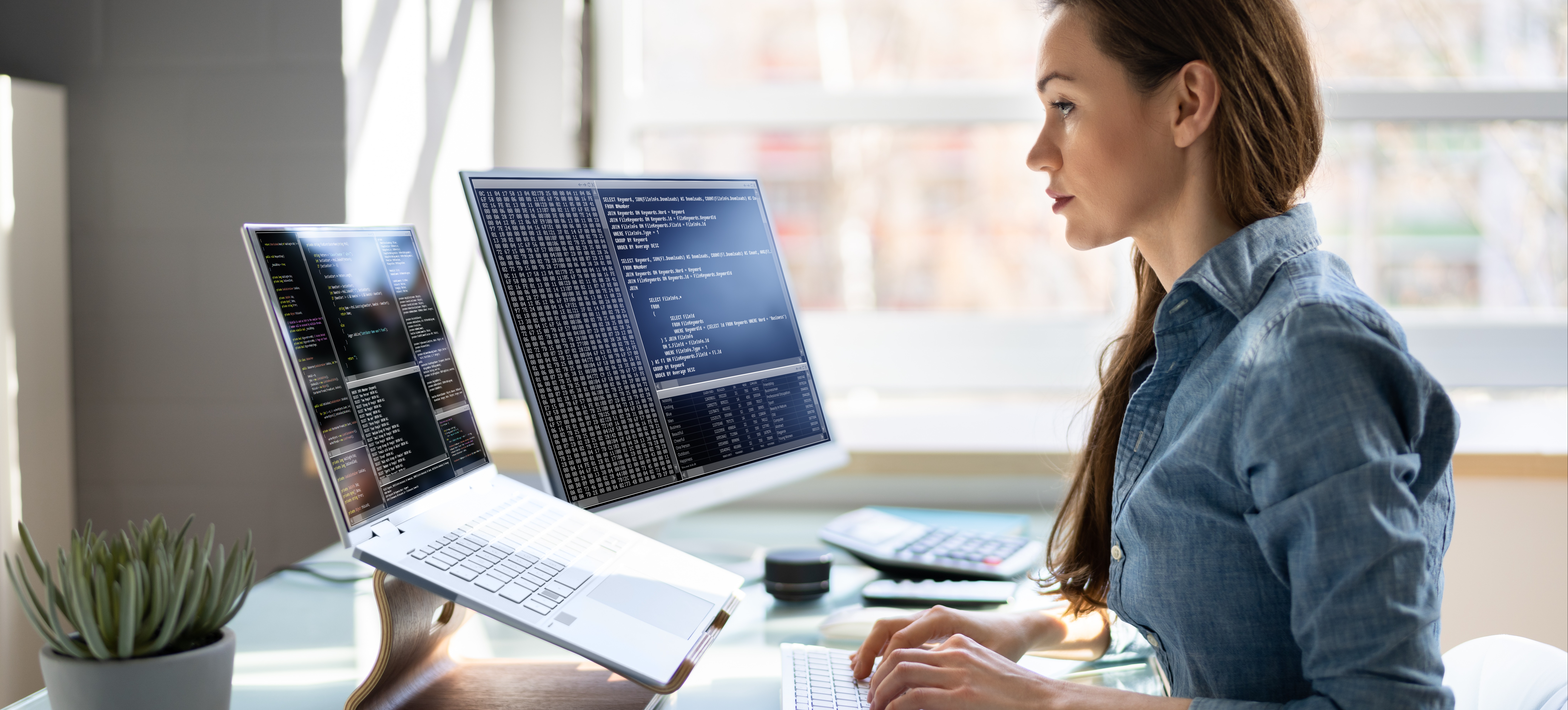 [Featured image] A data scientist works on cleaning some unstructured data at their workstation with a laptop and computer monitor.