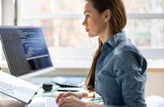 [Featured image] A data scientist works on cleaning some unstructured data at her workstation with a laptop and computer monitor.