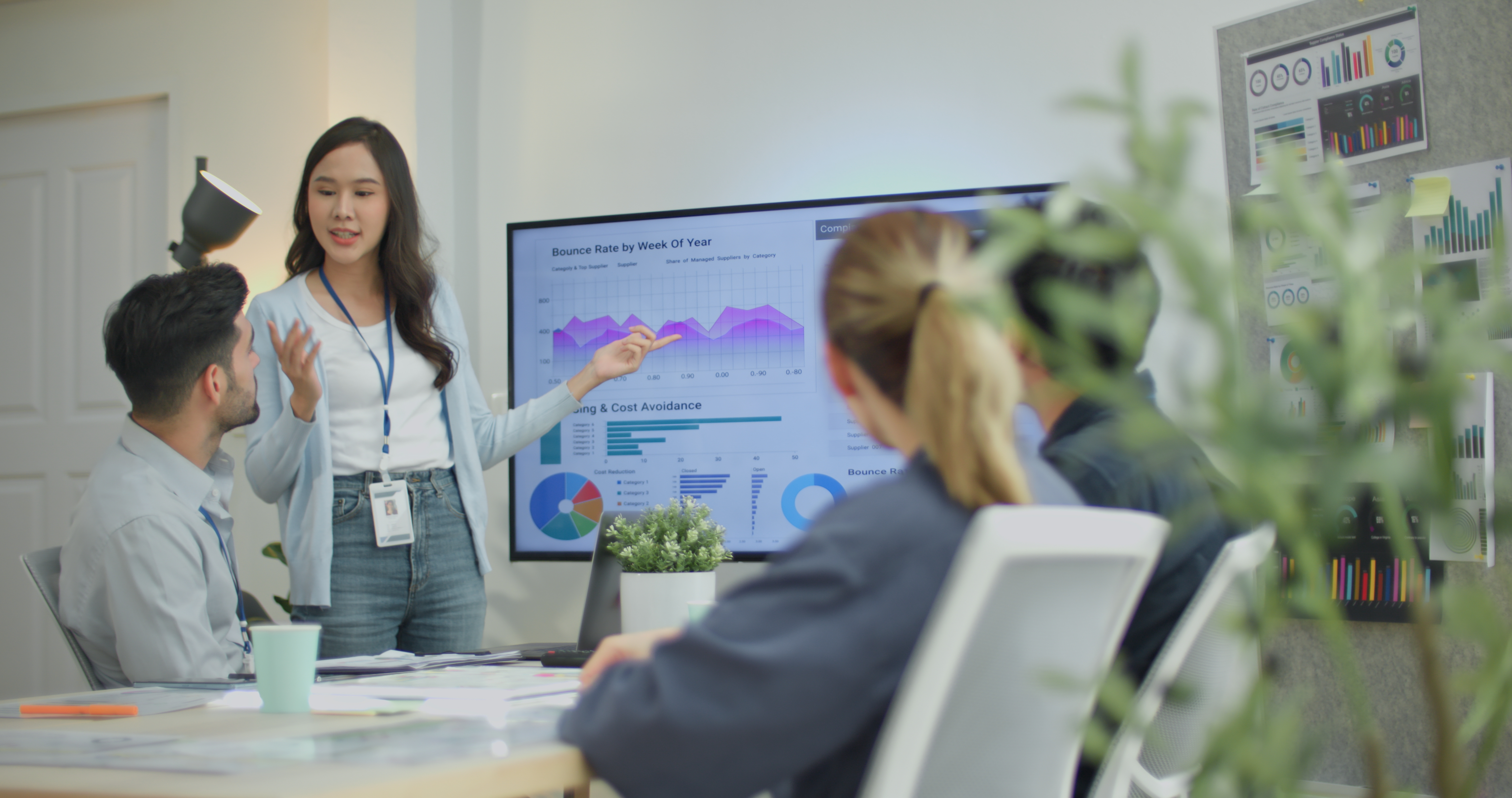 [Featured Image] A business team is in a meeting reviewing the company's progress through information gathered through data governance software.