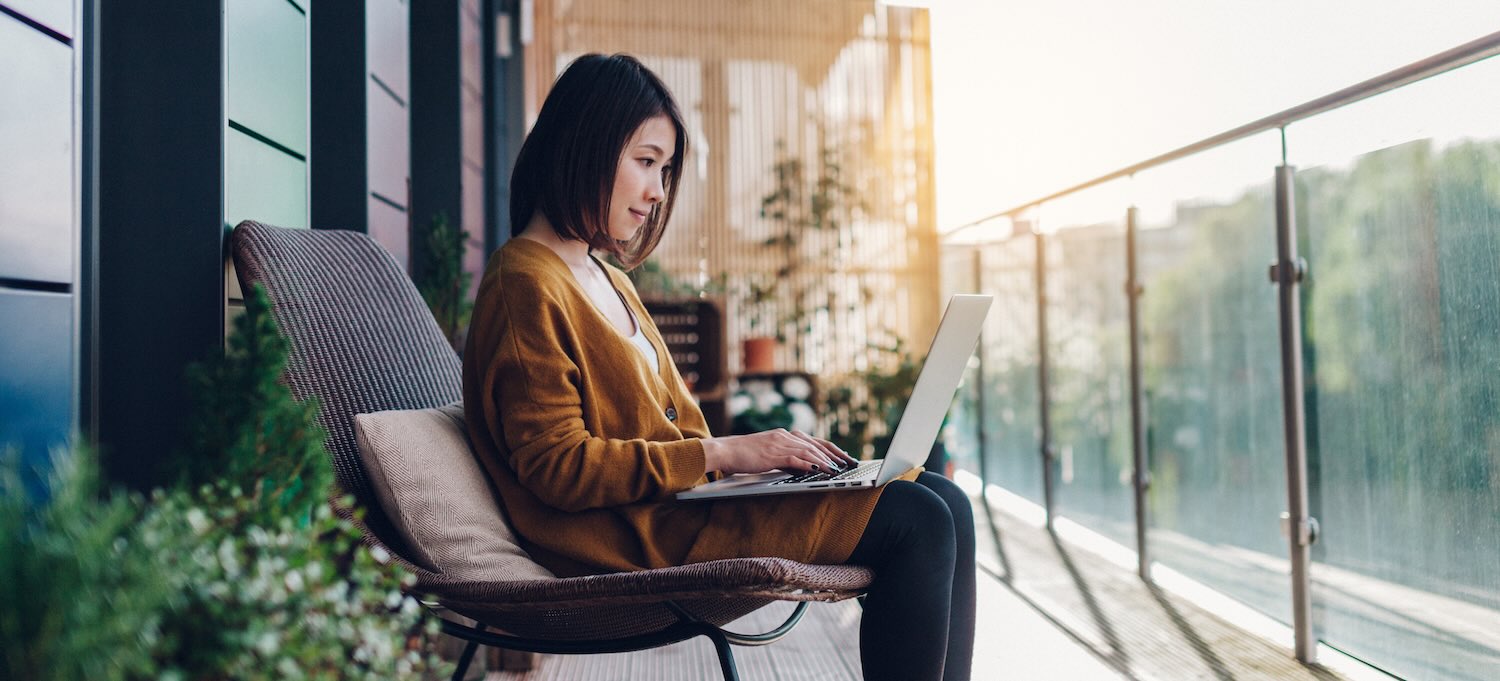 [Featured image] A data analyst sits on an outdoor patio with their laptop in their lap, working on their portfolio.