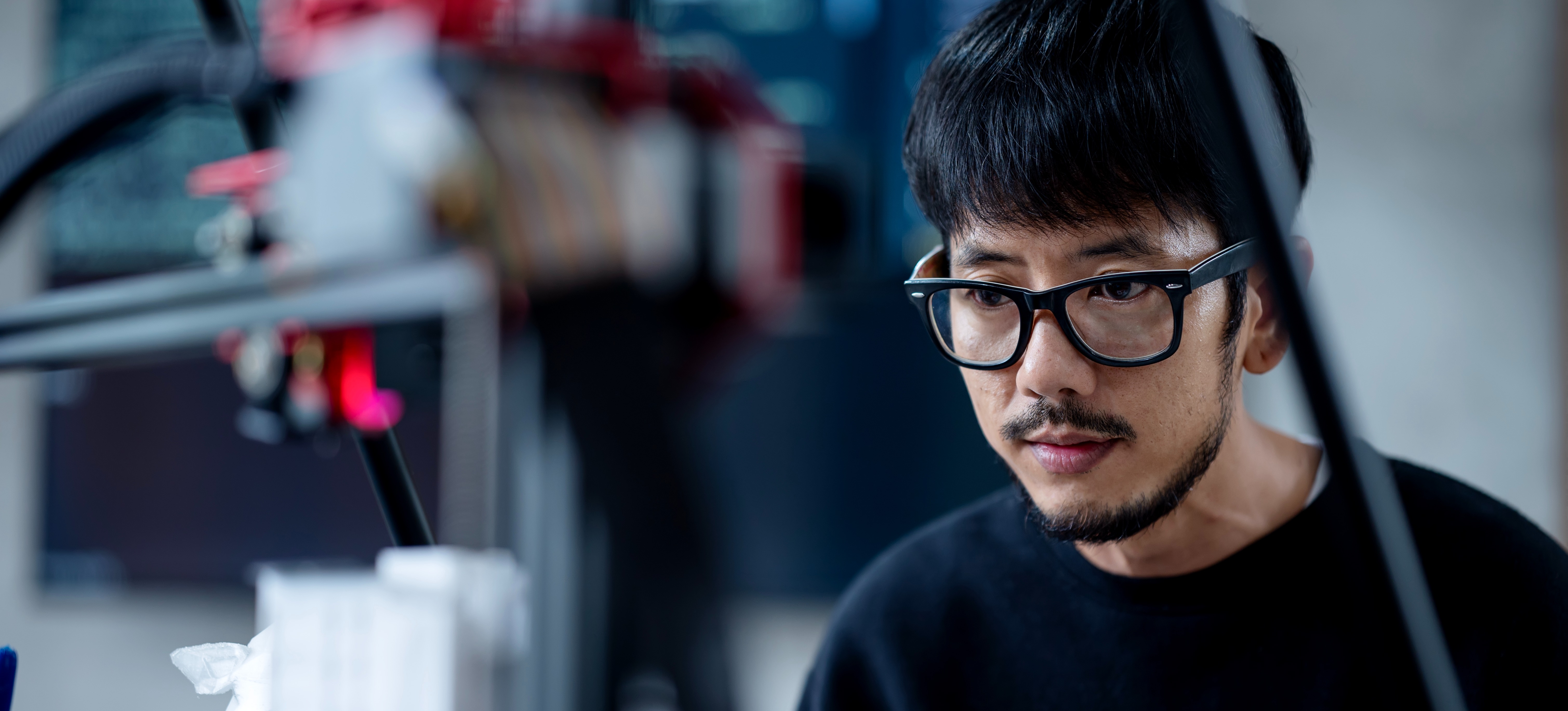 [Featured Image] A computer programmer is hyperparameter tuning on a learning machine at work.
