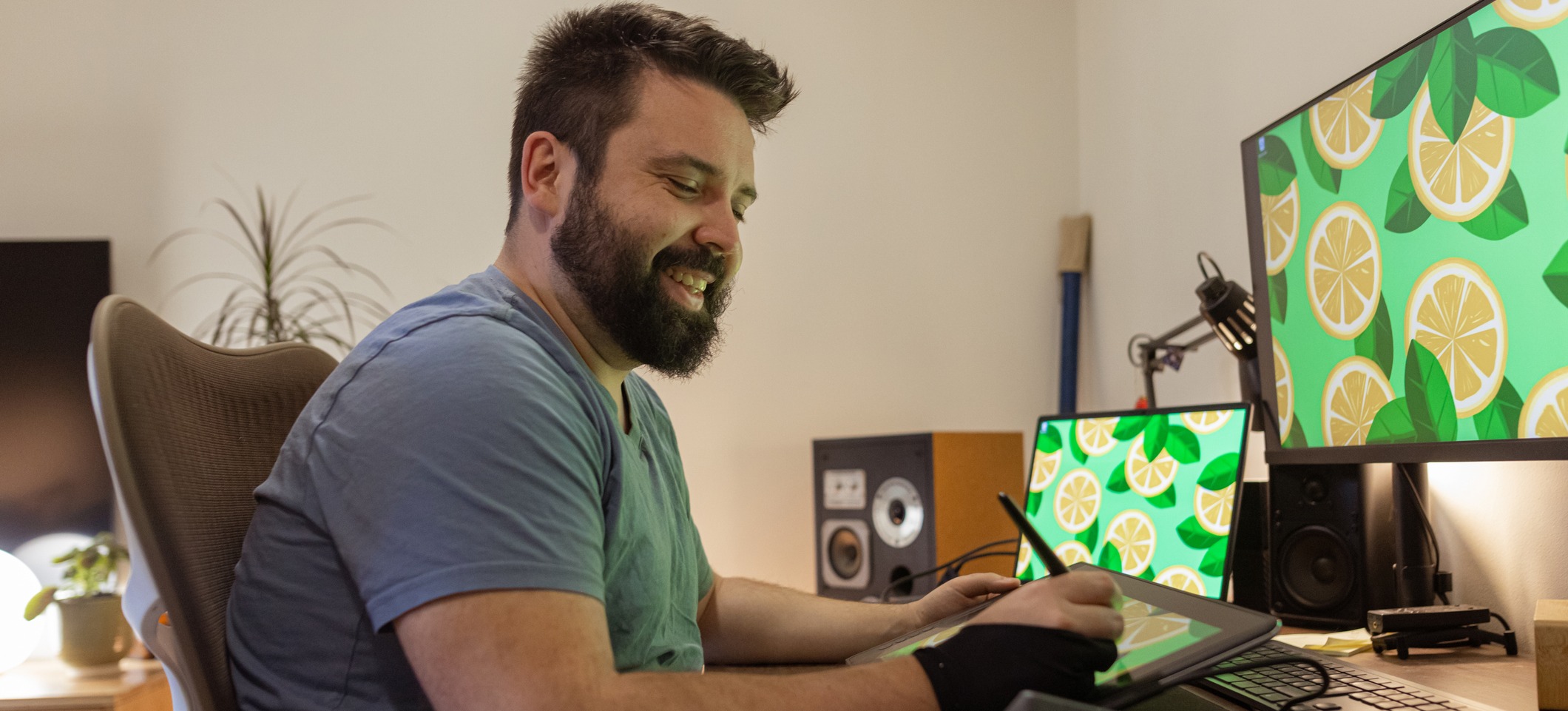 [Featured Image] A graphic designer in a home office working on a design project using different techniques to improve graphic design skills.
