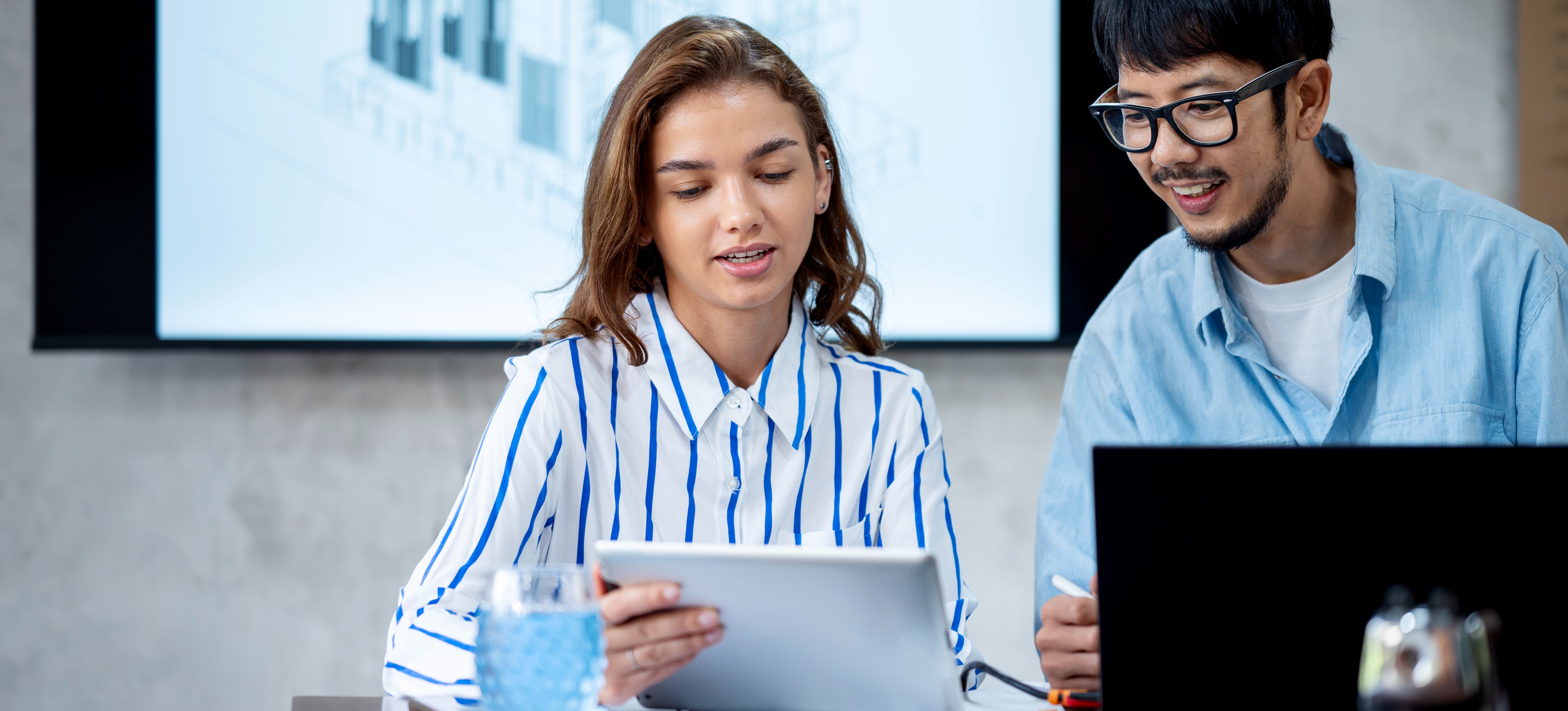 [Featured Image] Certified Kubernetes administrators collaborate in a workspace, smiling and interacting while they discuss Kubernetes administration.
