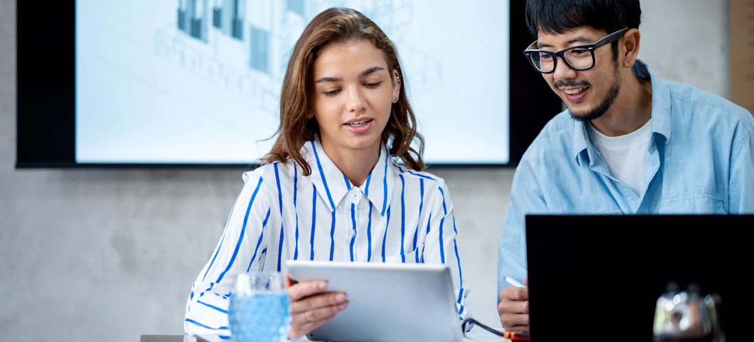 [Featured Image] Certified Kubernetes administrators collaborate in a workspace, smiling and interacting while they discuss Kubernetes administration.
