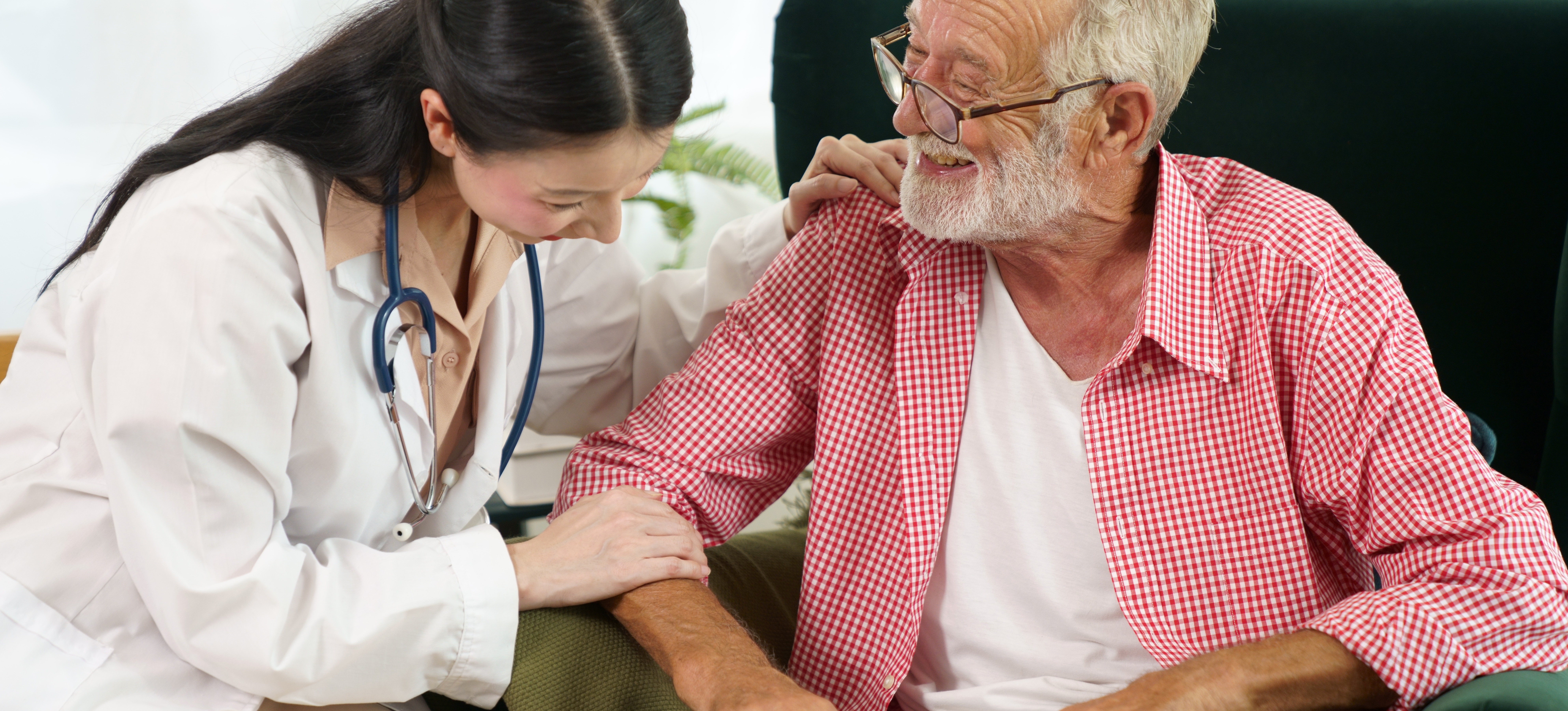 [Featured Image] A public health employee helps an elderly patient fill out paperwork. 