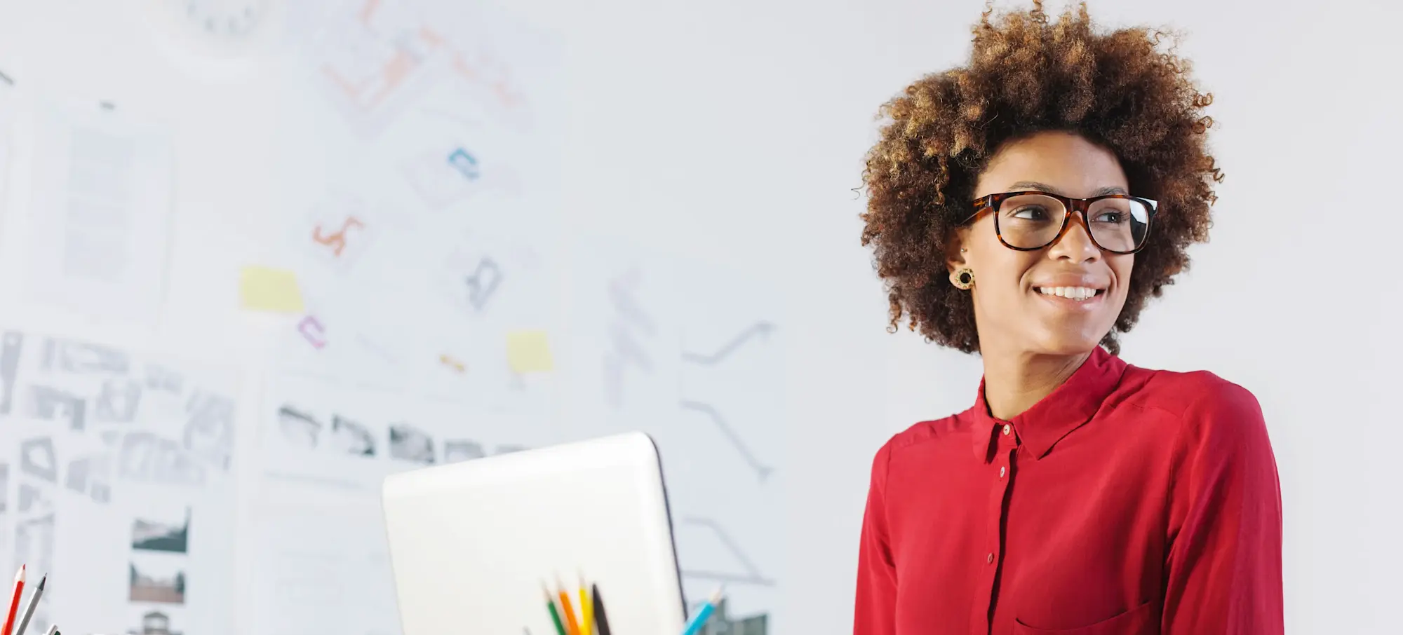 [Featured Image] A smiling business leader working at her computer.
