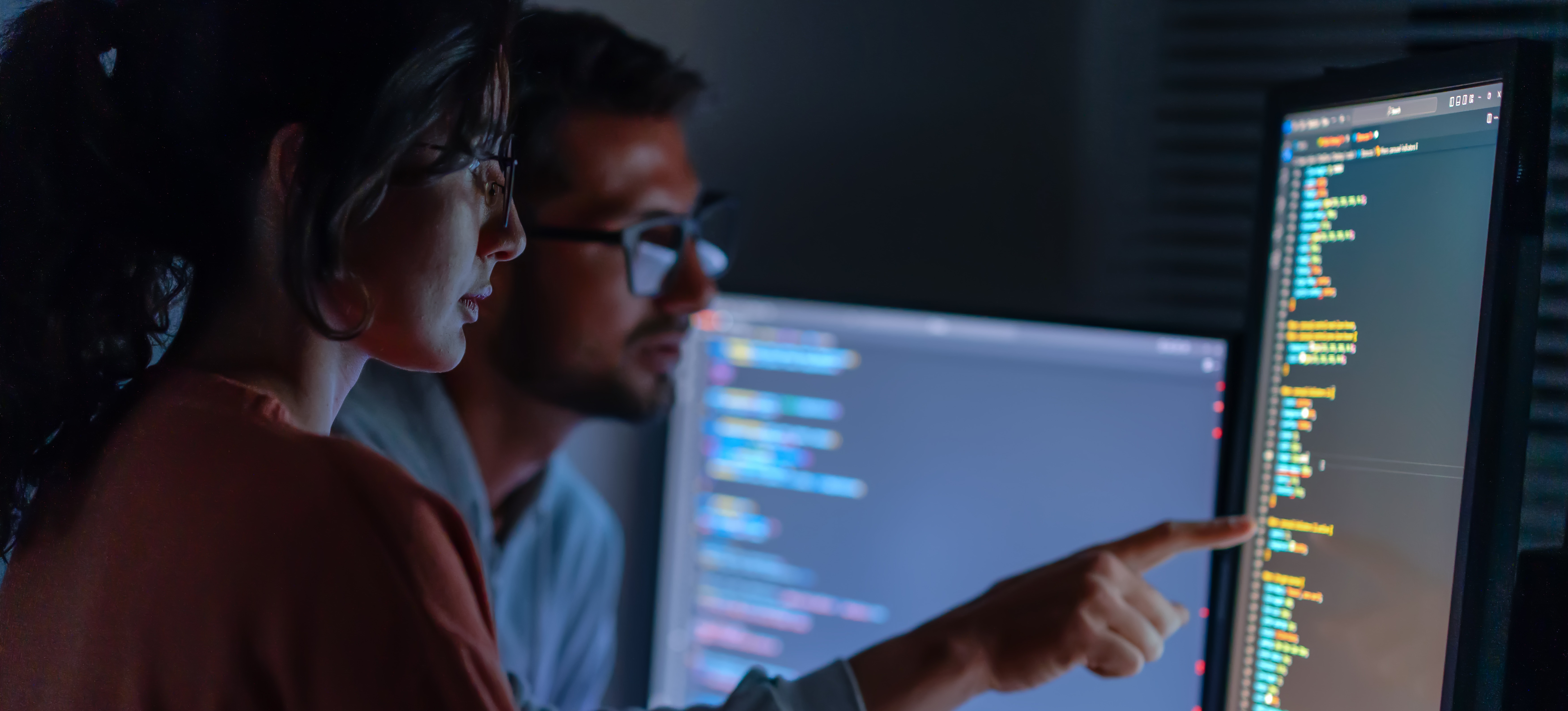 [Featured image] Two SOC analysts are reviewing code for their employer. 