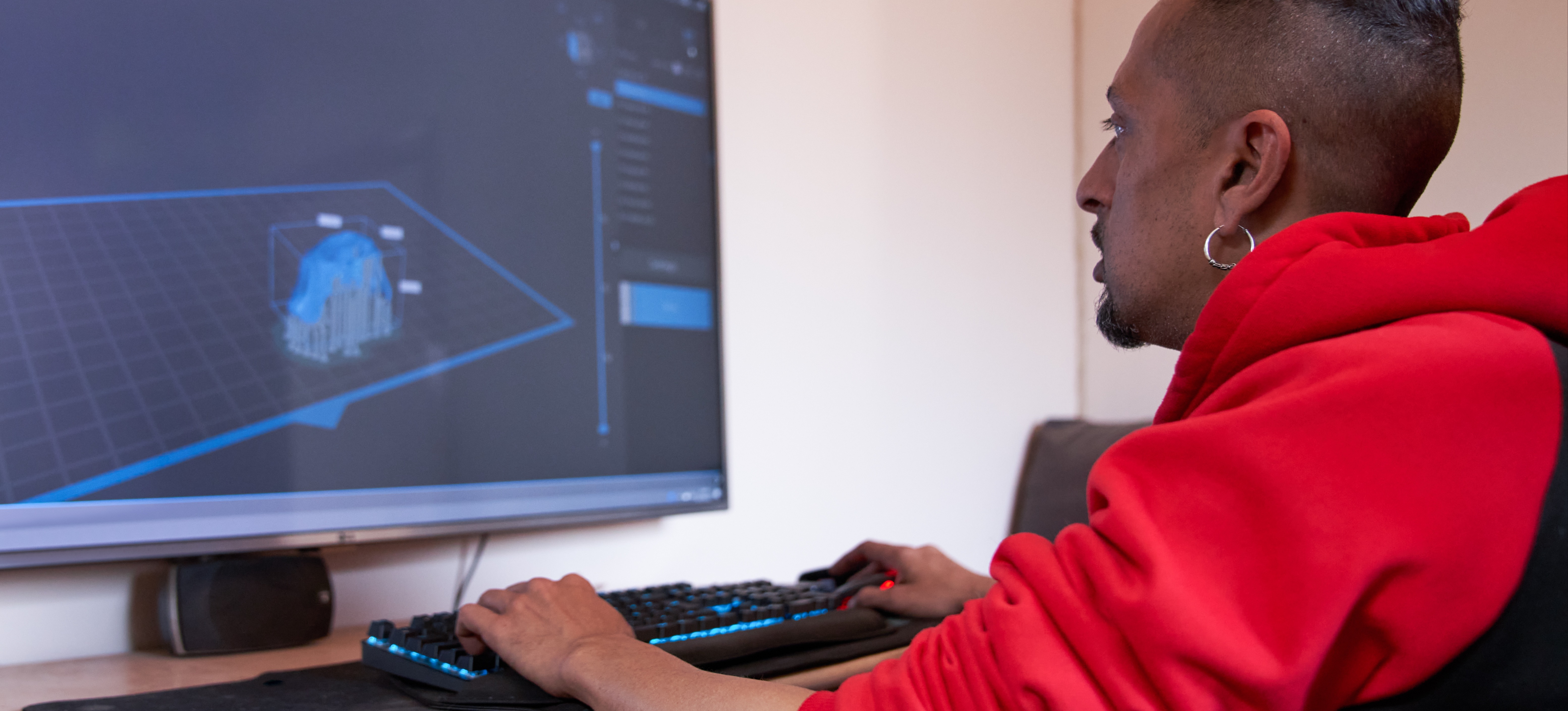 [Featured Image] A game designer working from home, using a game development platform on their computer to enhance their skills in game design.