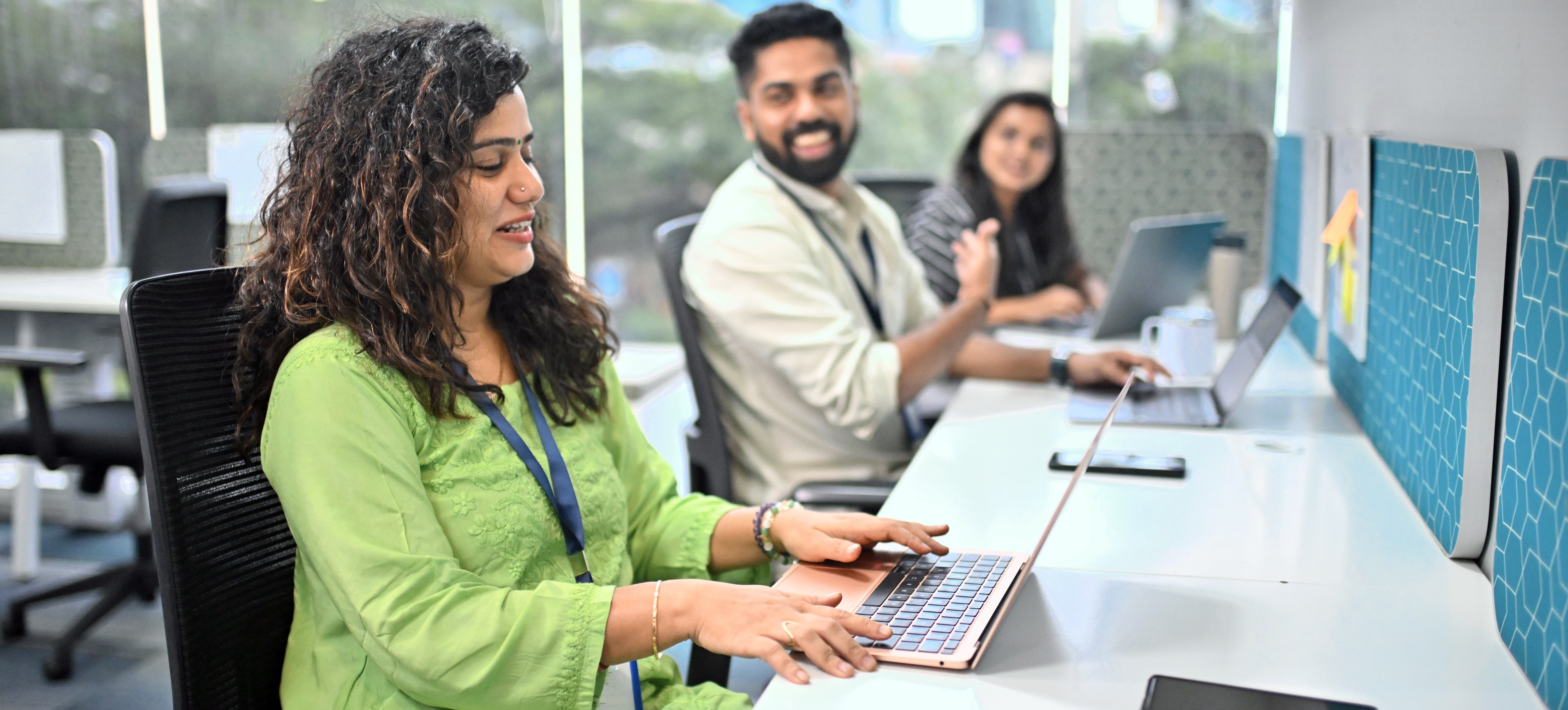[Featured Image] Three computer programming students are happy as they work on django projects.