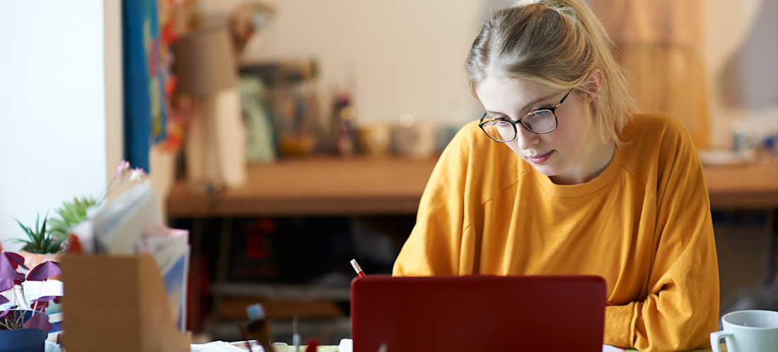 [Featured Image] A professional studies at a desk, seeking to update her skill set.
